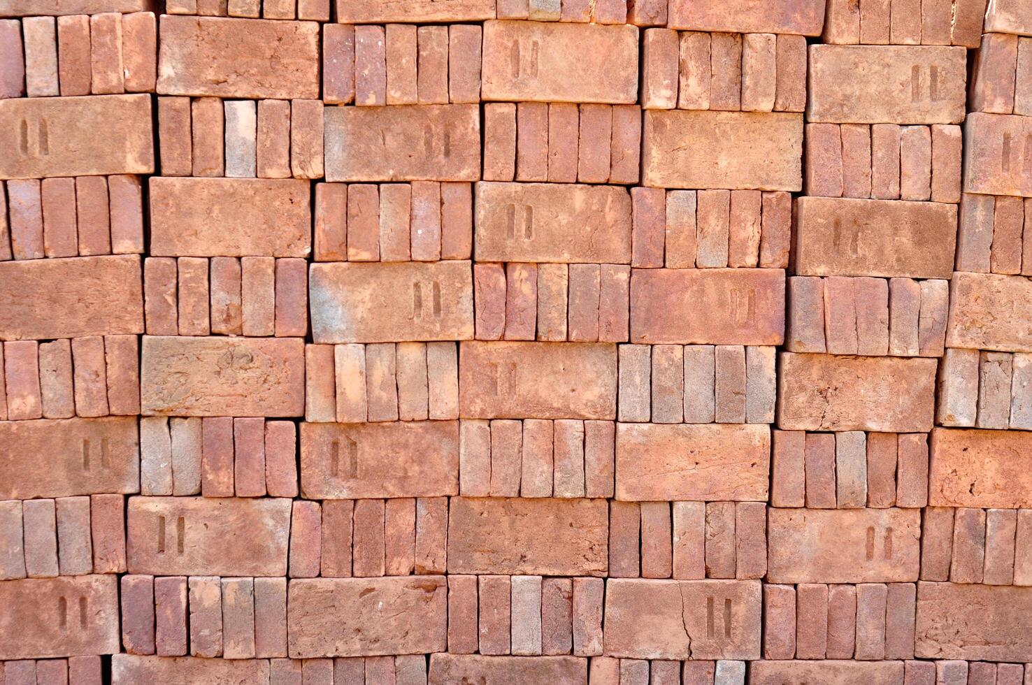 Pile of red bricks texture background photo
