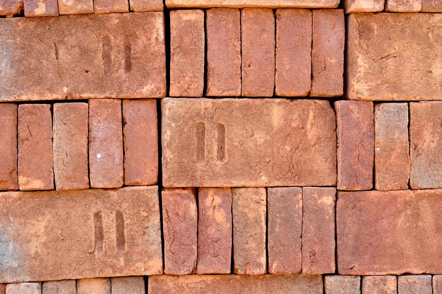Pile of red bricks texture background photo