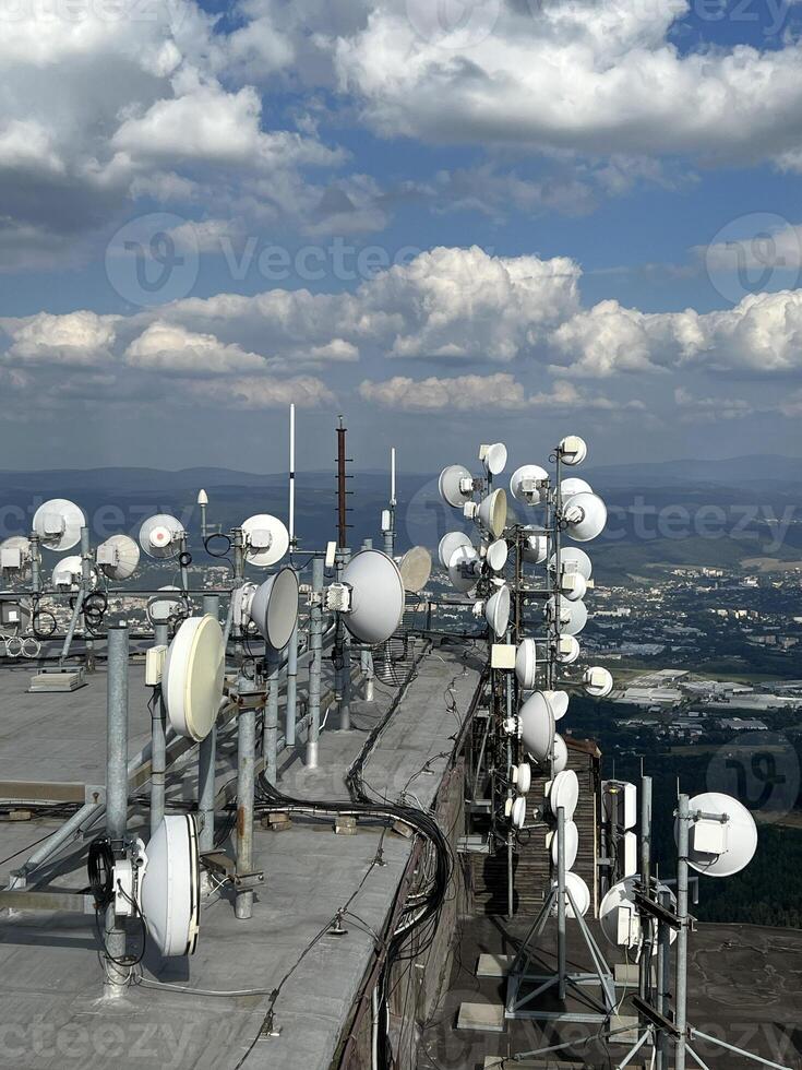 Radio transmitting center with many Radio link Stations microwave is located in peak mountains, with beautiful aerial view. Telecommunications tower inspection for cell phone, radio transmitters. photo