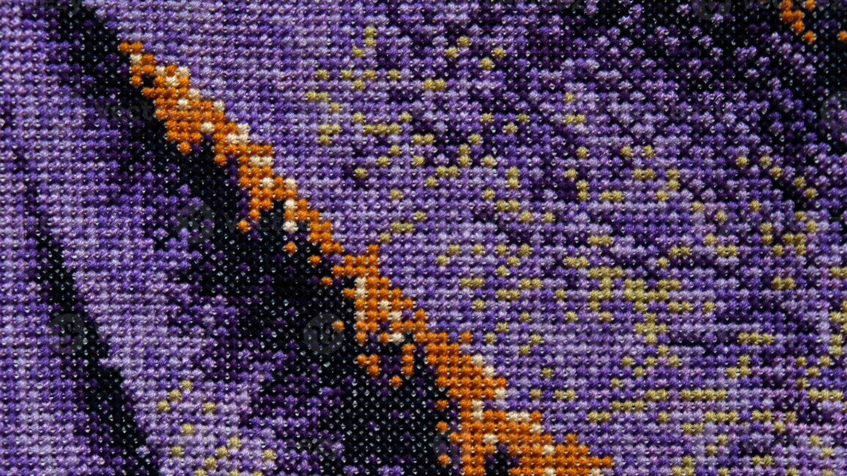 Purple, violet and brown close-up cross stitch background. Abstract Embroidered handmade Pattern. Needlework and DIY concept. Top view, macro, flat lay, mockup. photo