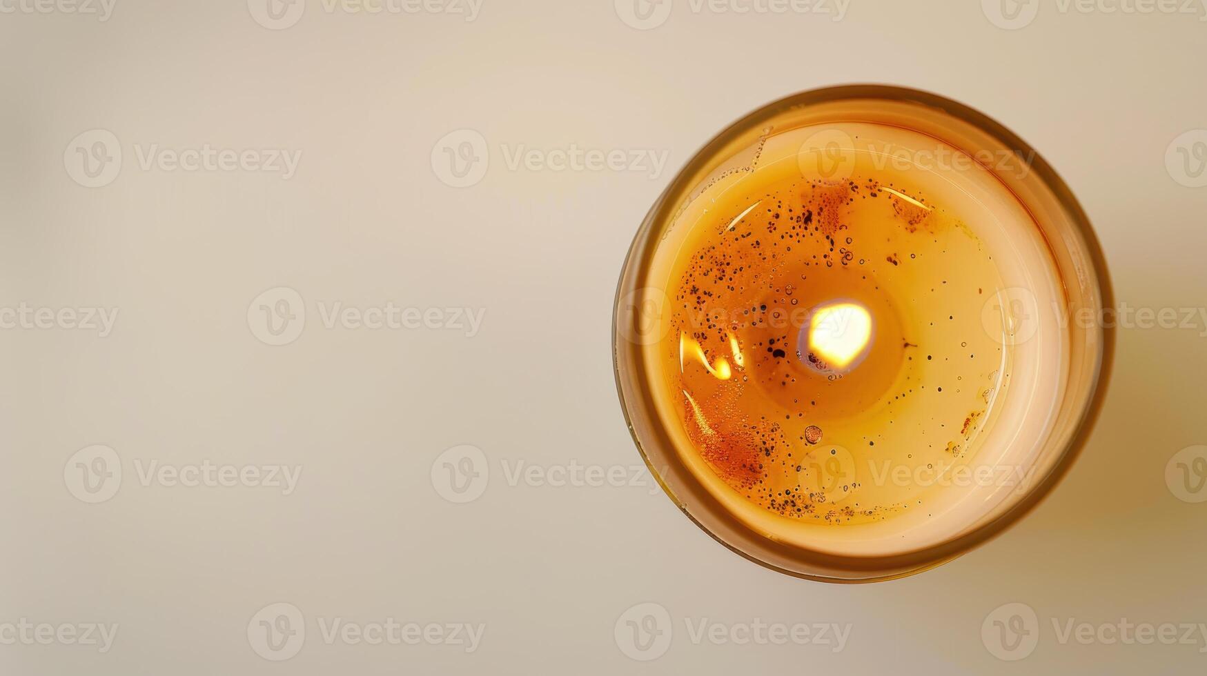 Close-up of a scented candle with a warm, inviting flame, creating a cozy ambiance photo