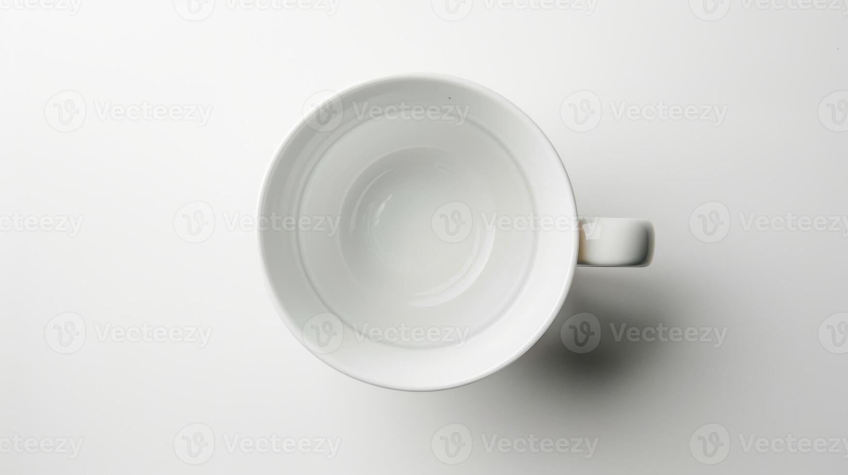 Empty white coffee mug on a blank background, waiting to be filled photo