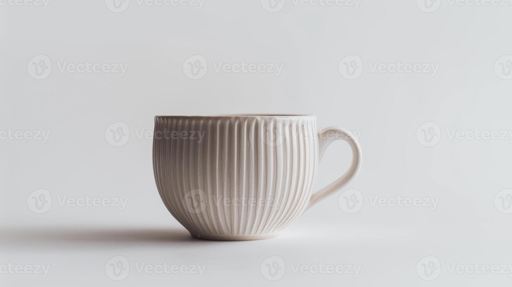 Modern white ceramic mug with a simple design is standing on a white background photo