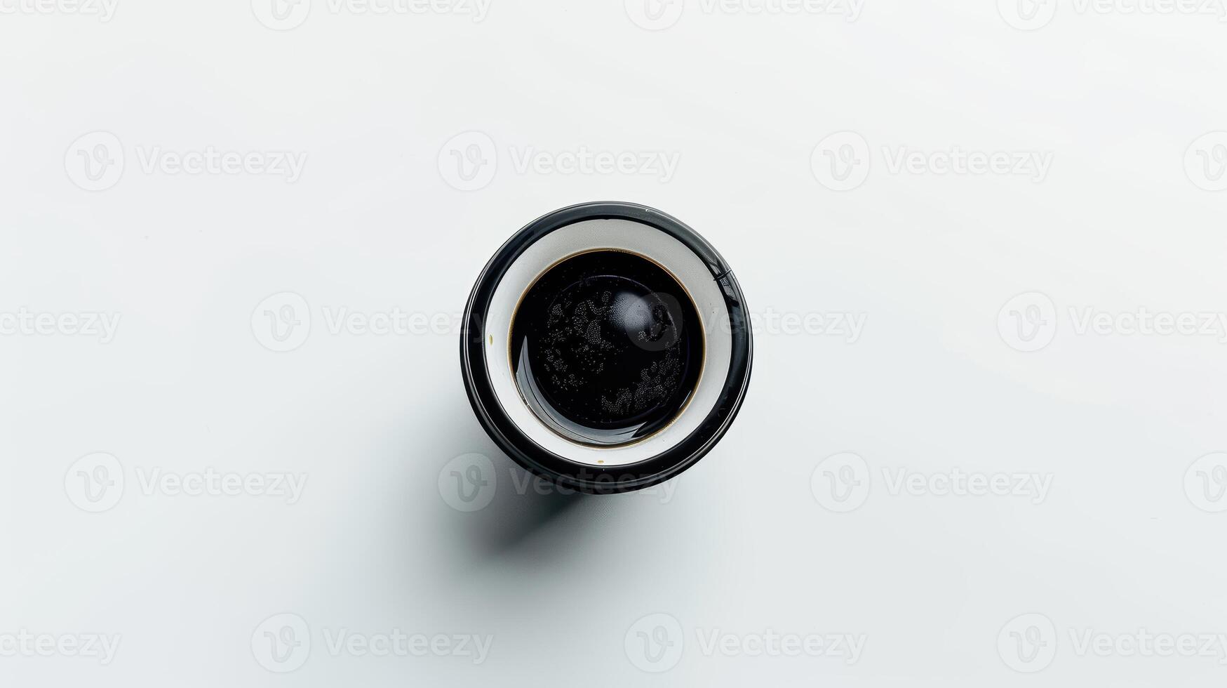Directly above shot of a plain black coffee mug on a white background photo
