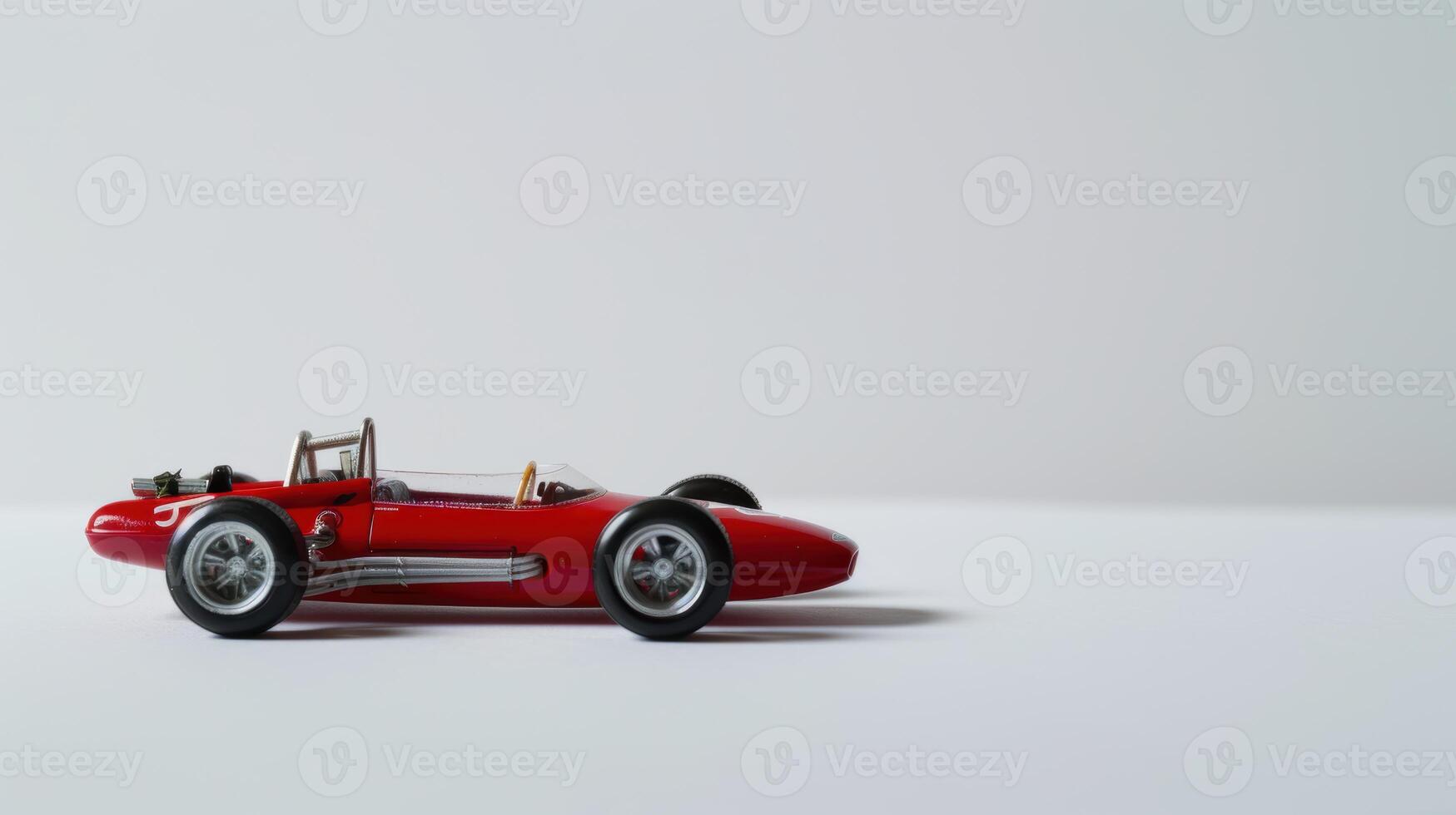 Red toy race car on a white background symbolizing speed, competition, and racing photo