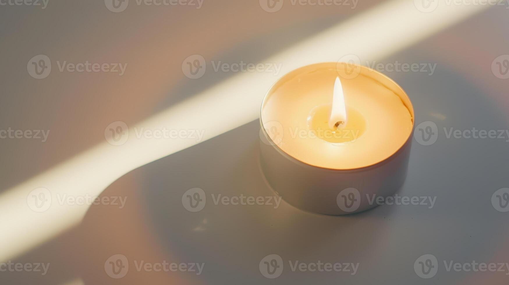 White burning scented candle is standing on a table and creating cozy atmosphere at home photo