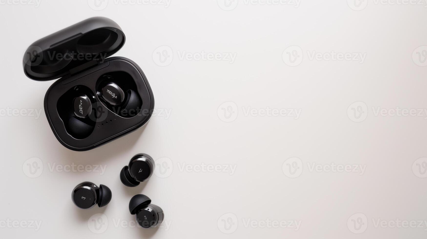 Wireless stereo earbuds and their charging case resting on a white table, ready for use photo