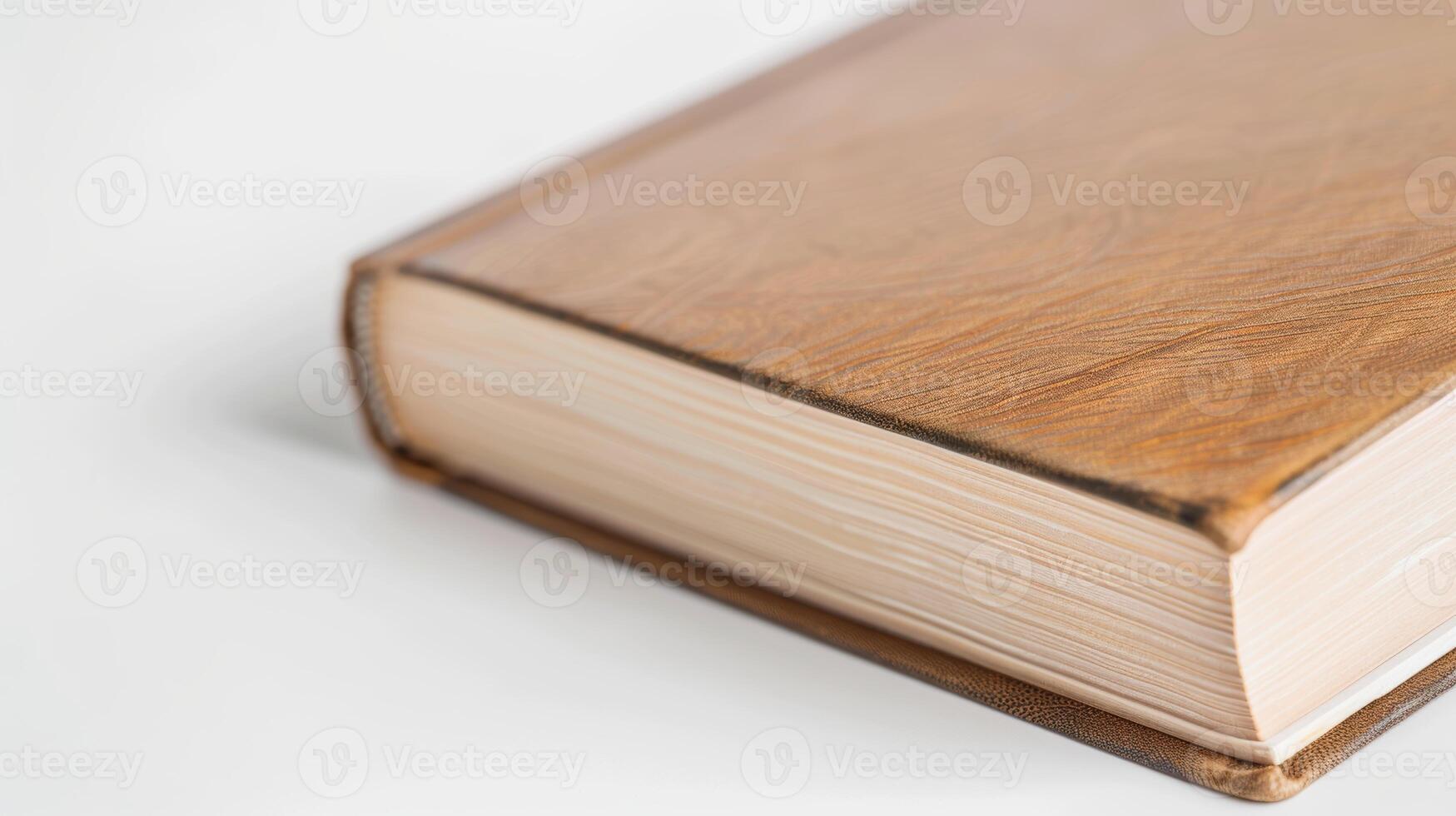Old leather-bound book with yellowed pages on a white table, exuding wisdom and charm photo