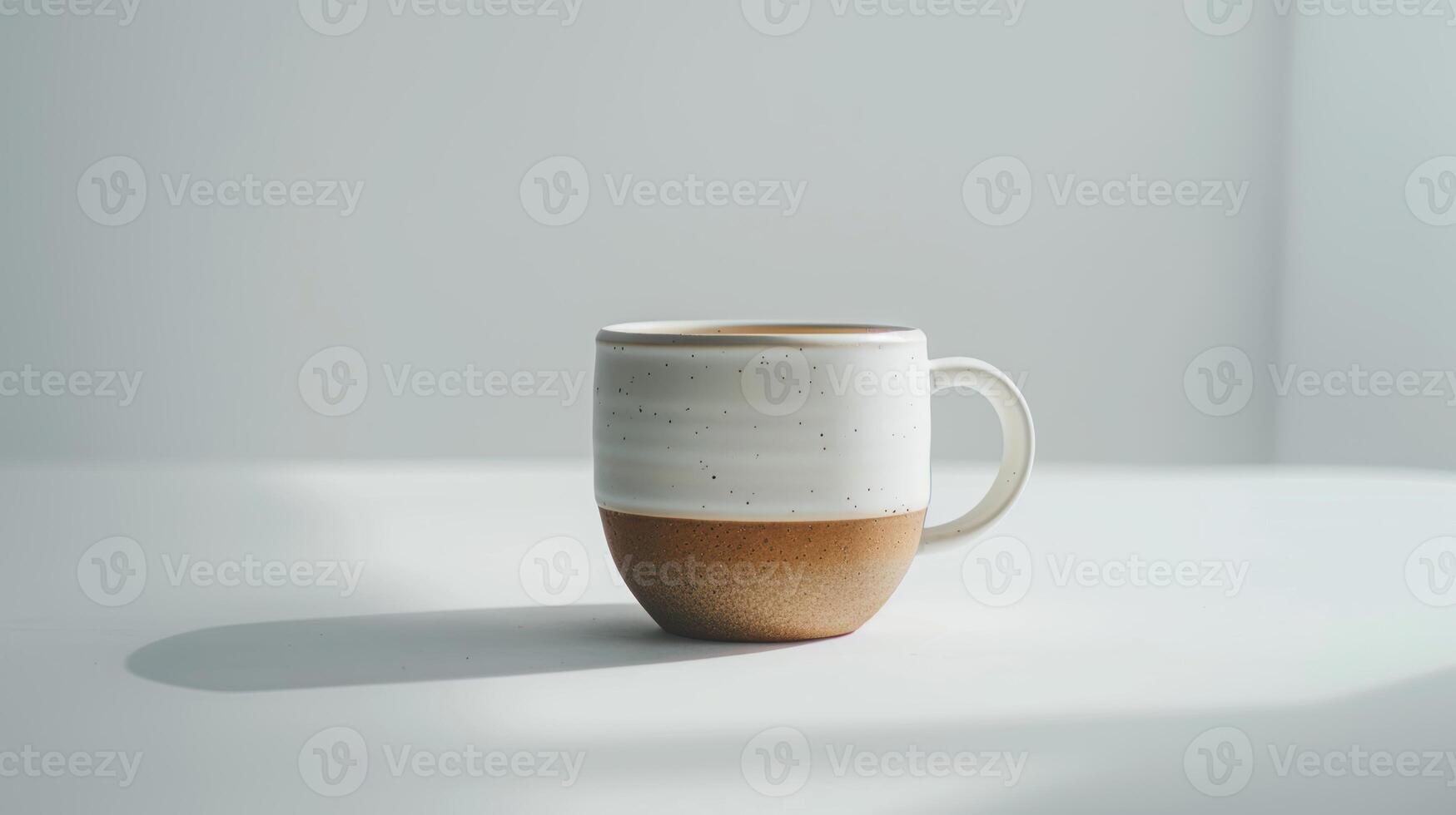 In a modern and bright setting, a simple white and brown ceramic mug is casting a shadow photo