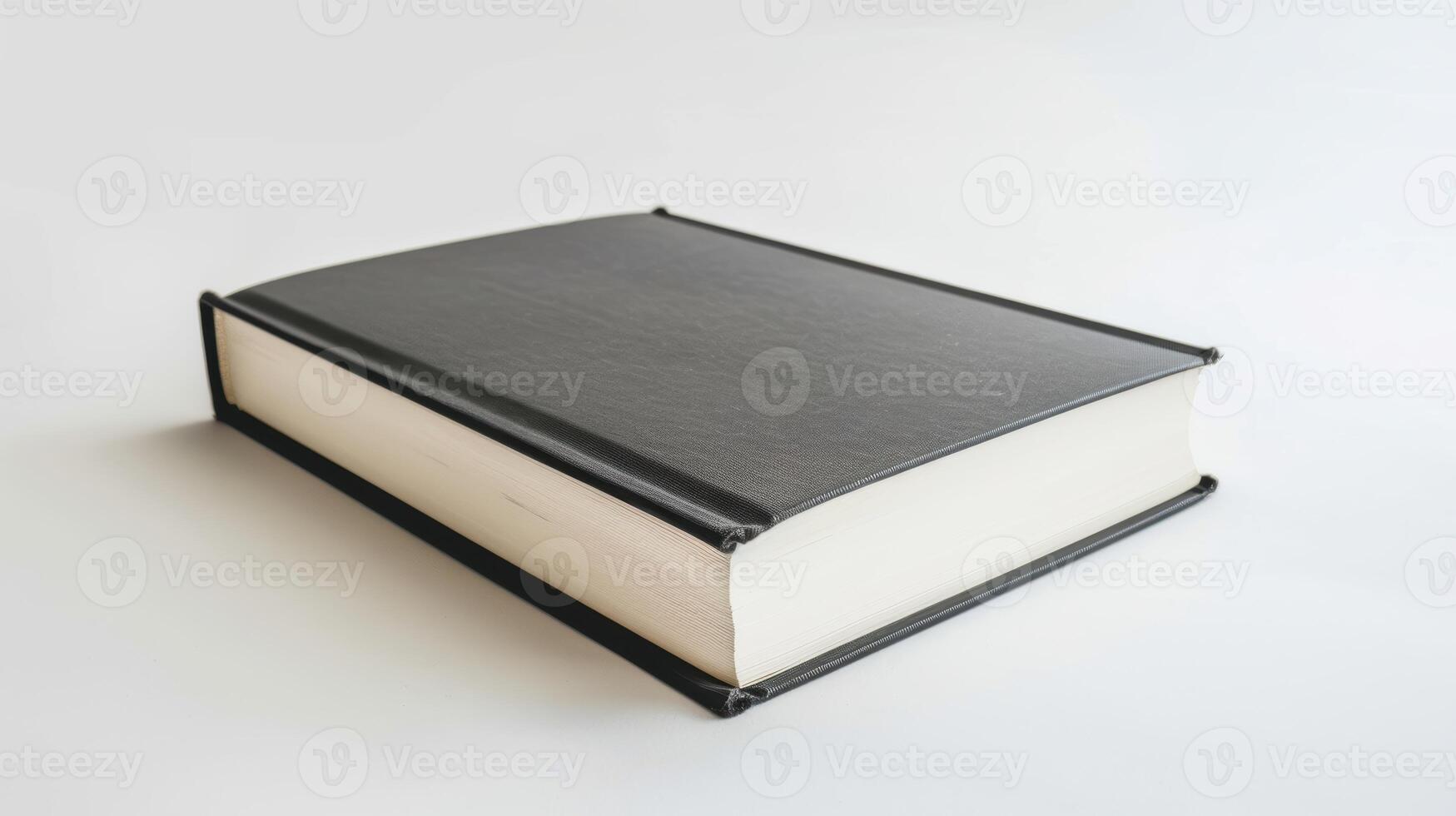 Closed black hardcover book rests on a white surface, symbolizing learning, scholarship photo