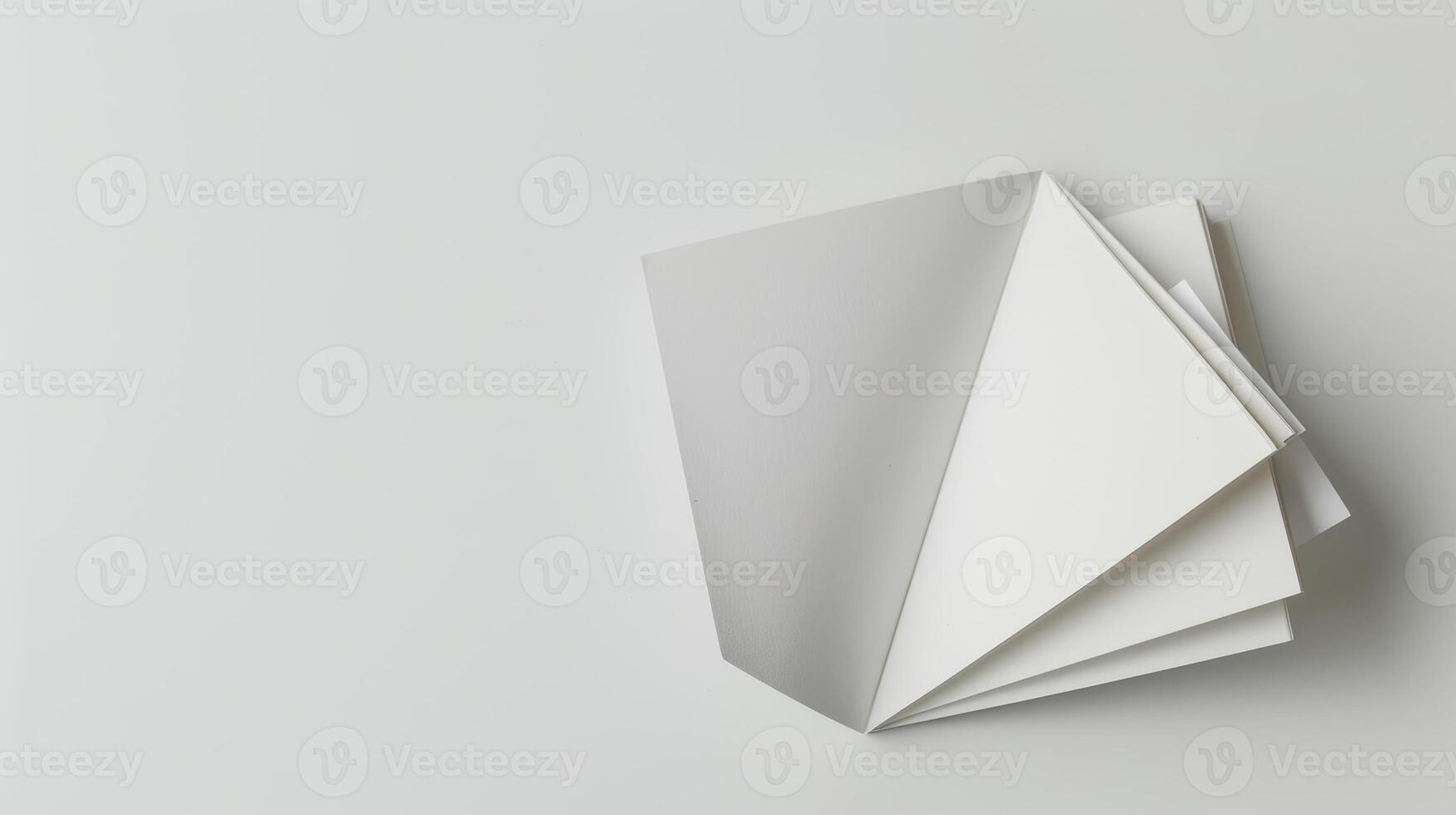Blank magazine displayed with pages fanning out to create an abstract geometric design photo