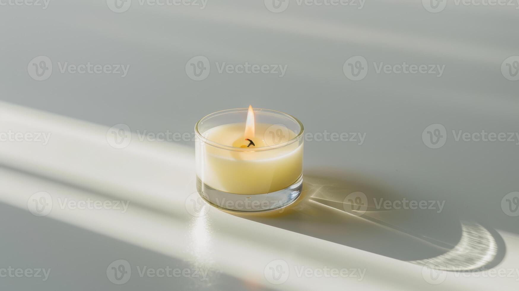 Burning scented candle is spreading relaxing fragrance at home on a sunlit table photo