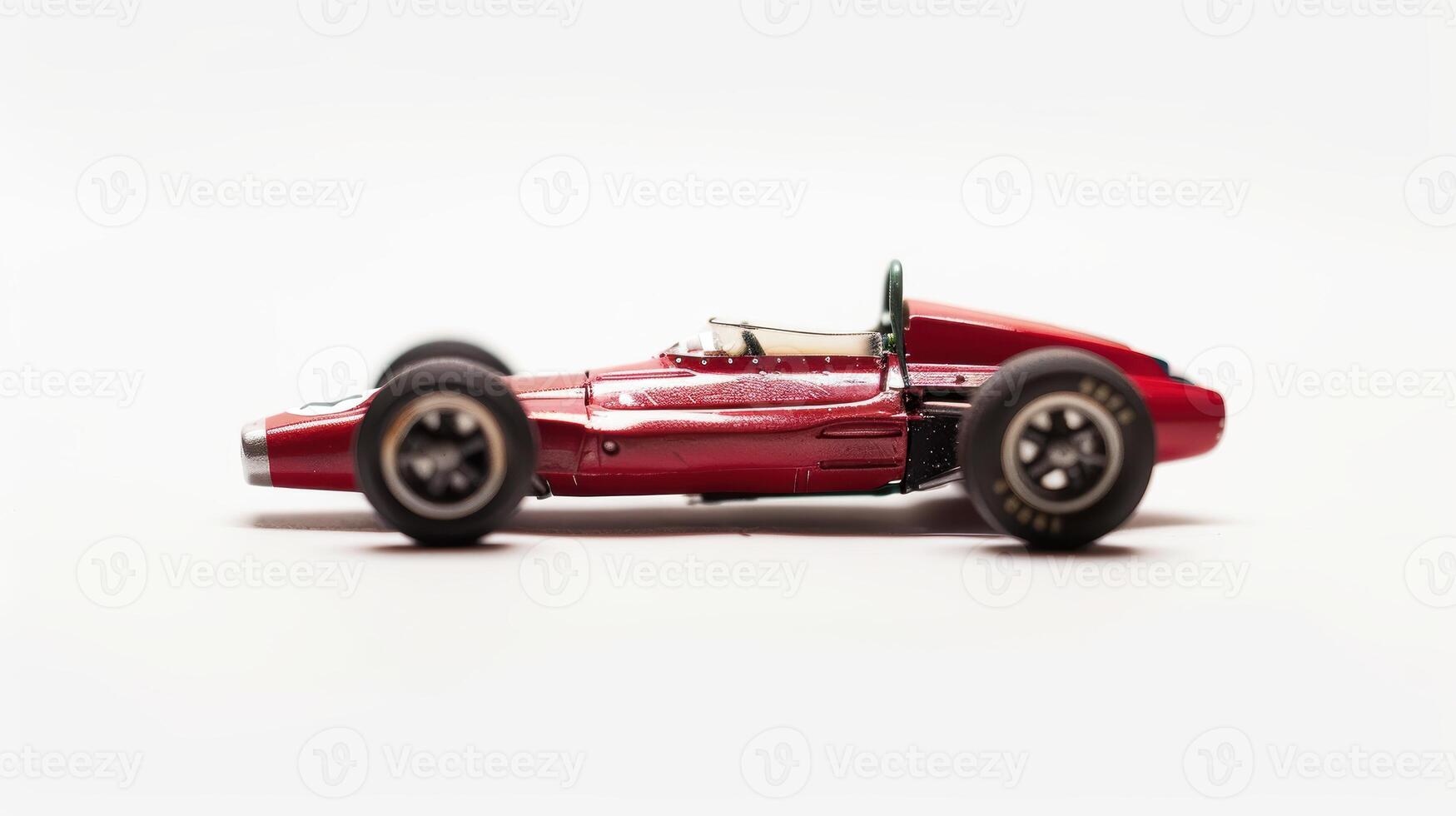 Red racing car model standing on a white background, its sleek design and vibrant color. photo