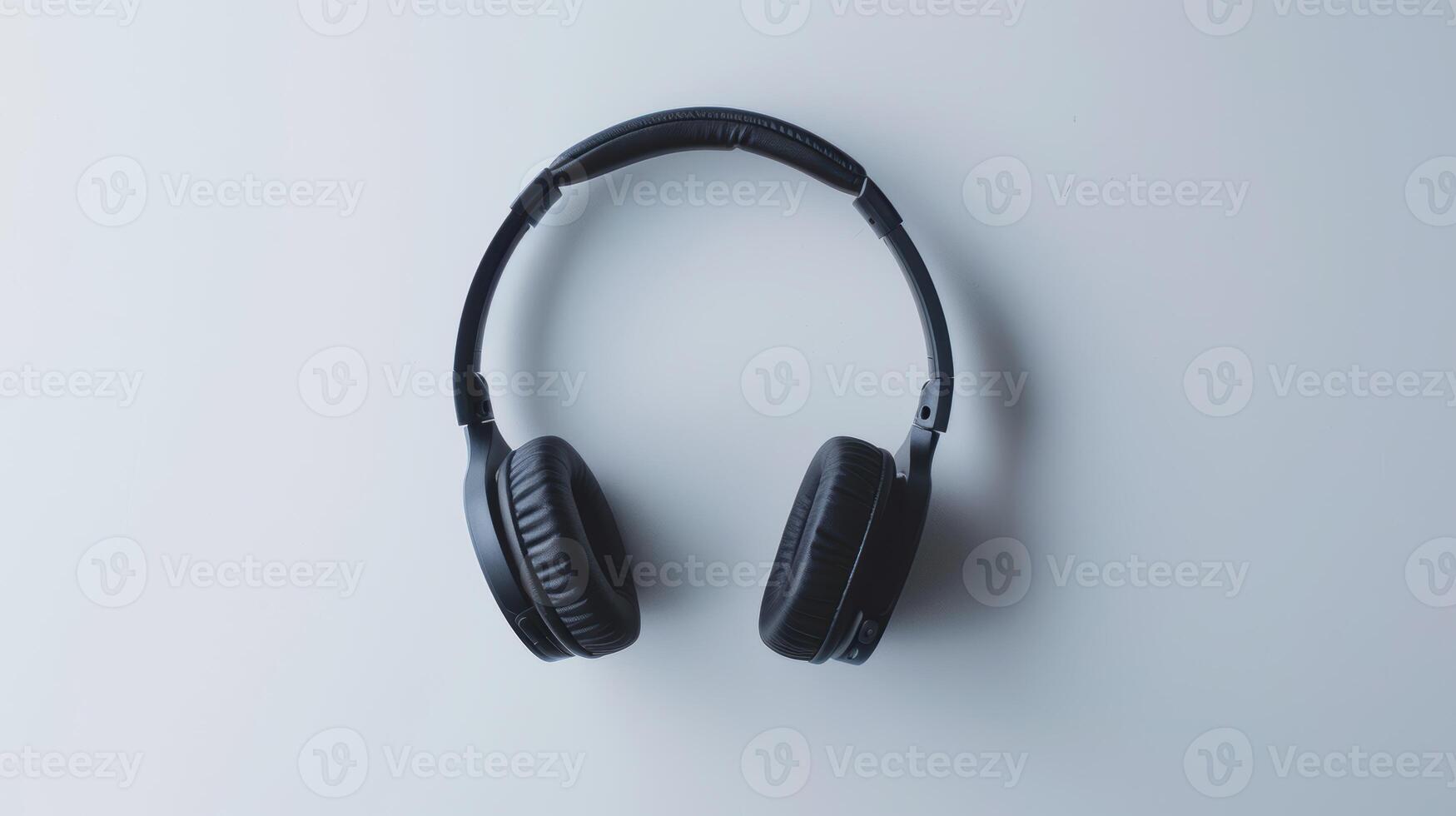 Black wireless headphones lying on a white background, a concept image about music photo