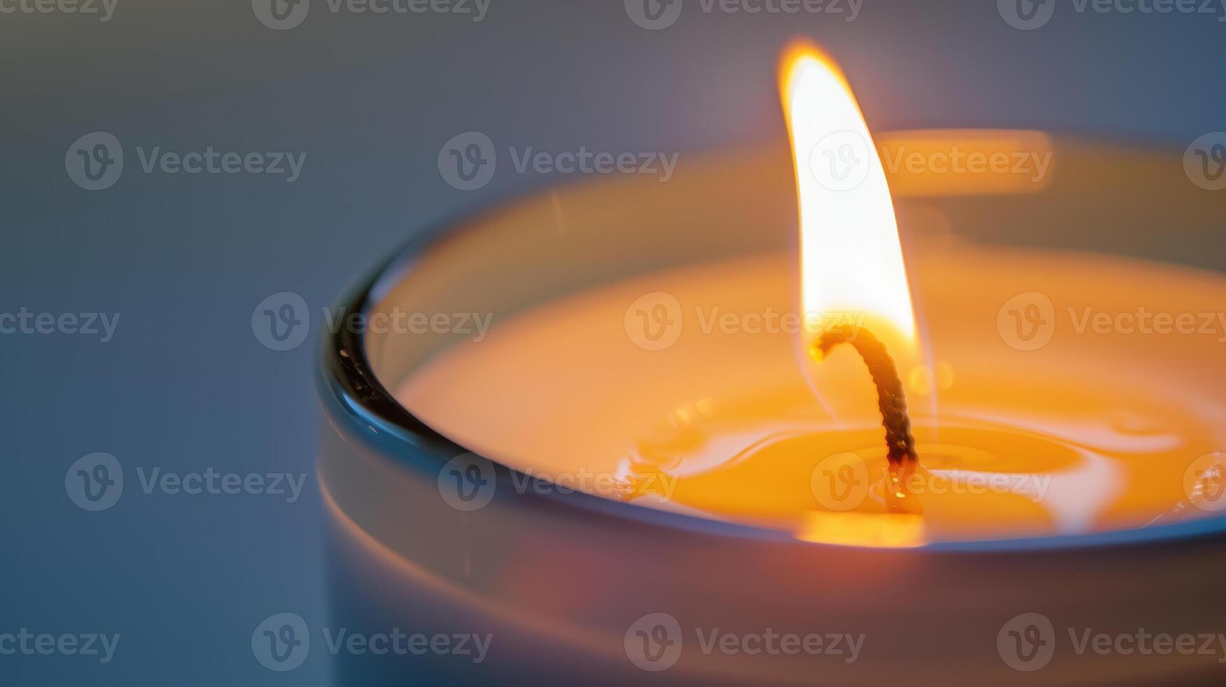 The soft yellow flame of a single white candle creates a warm and inviting glow photo