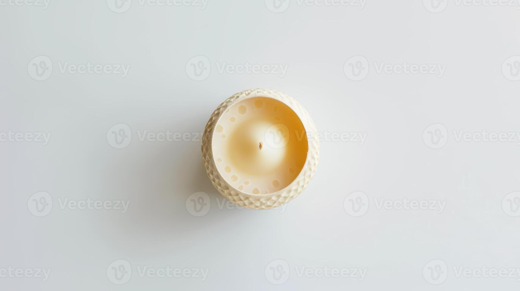 Round decorative scented candle with textured surface on a white backdrop photo