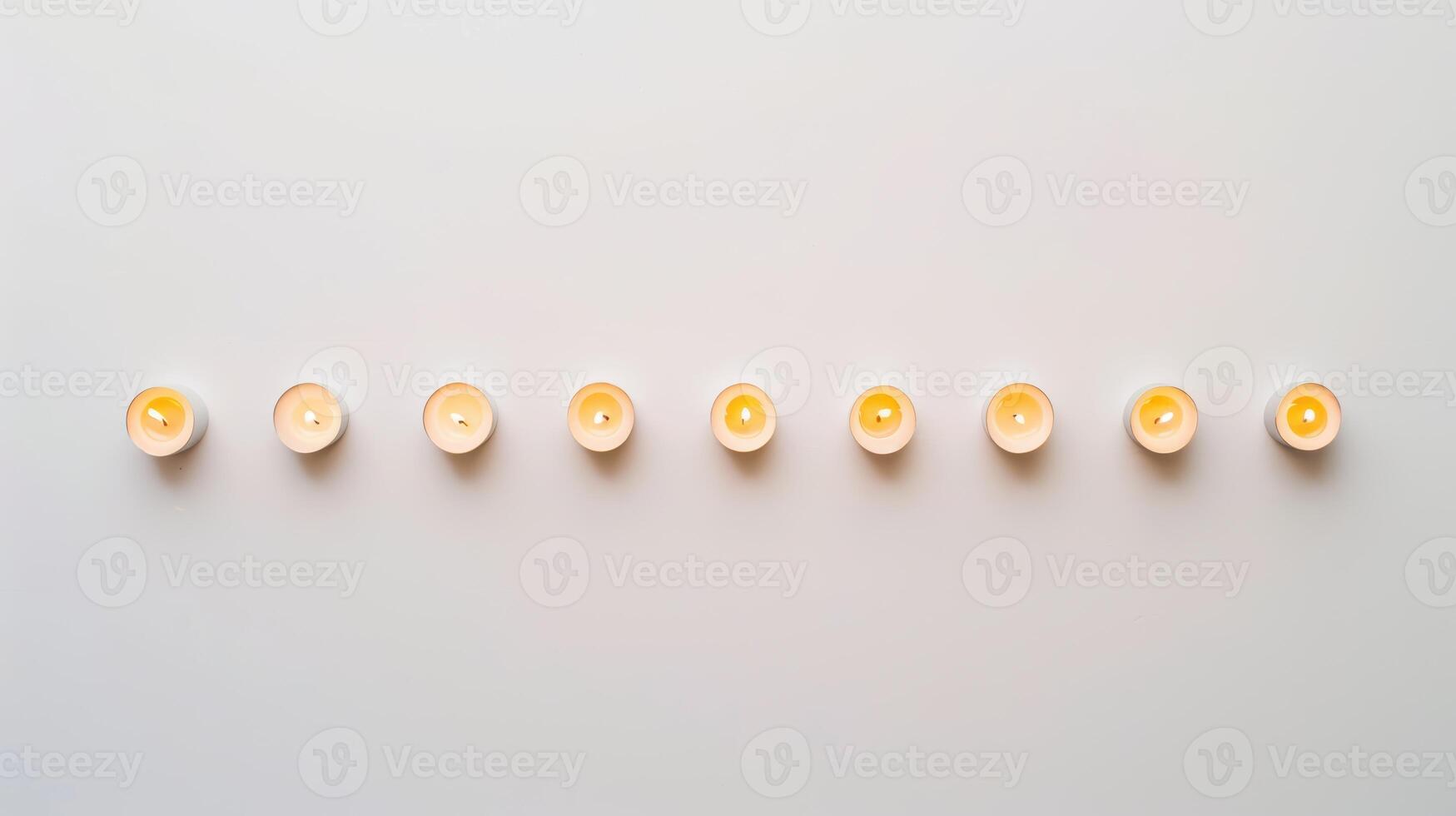 Ten glowing tea light candles casting a tranquil and serene ambiance against a white backdrop photo