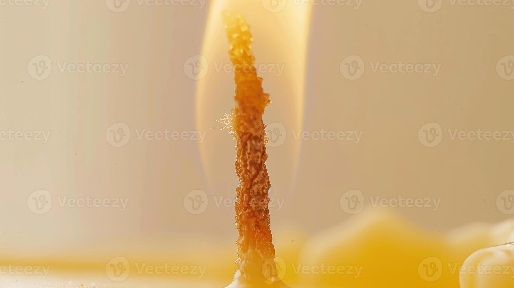 Up-close look at a flickering candle flame, casting a cozy and welcoming light on its surroundings photo