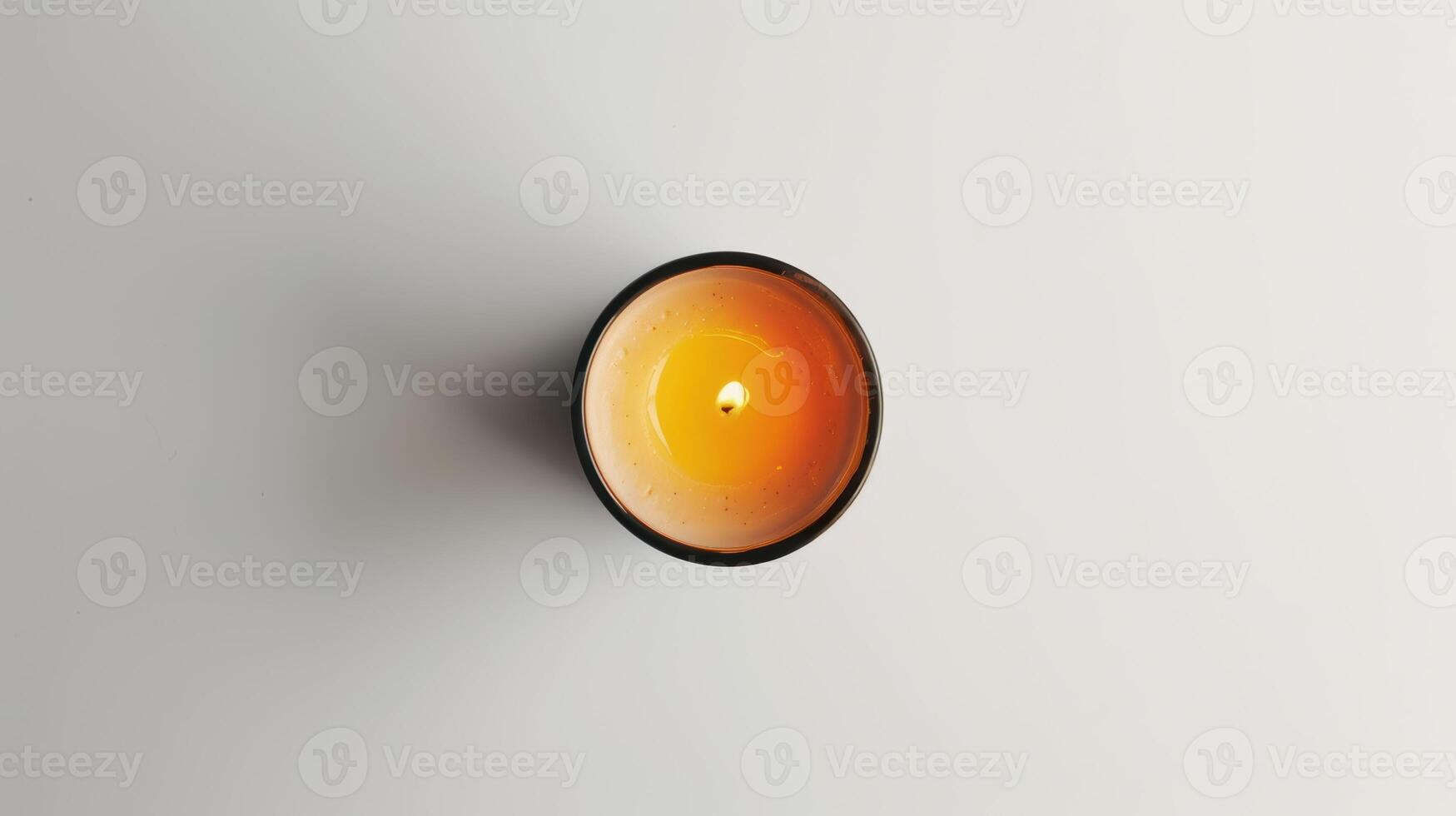 Single round aromatic candle emits a soft yellow flame, casting a warm and inviting glow, White BG photo