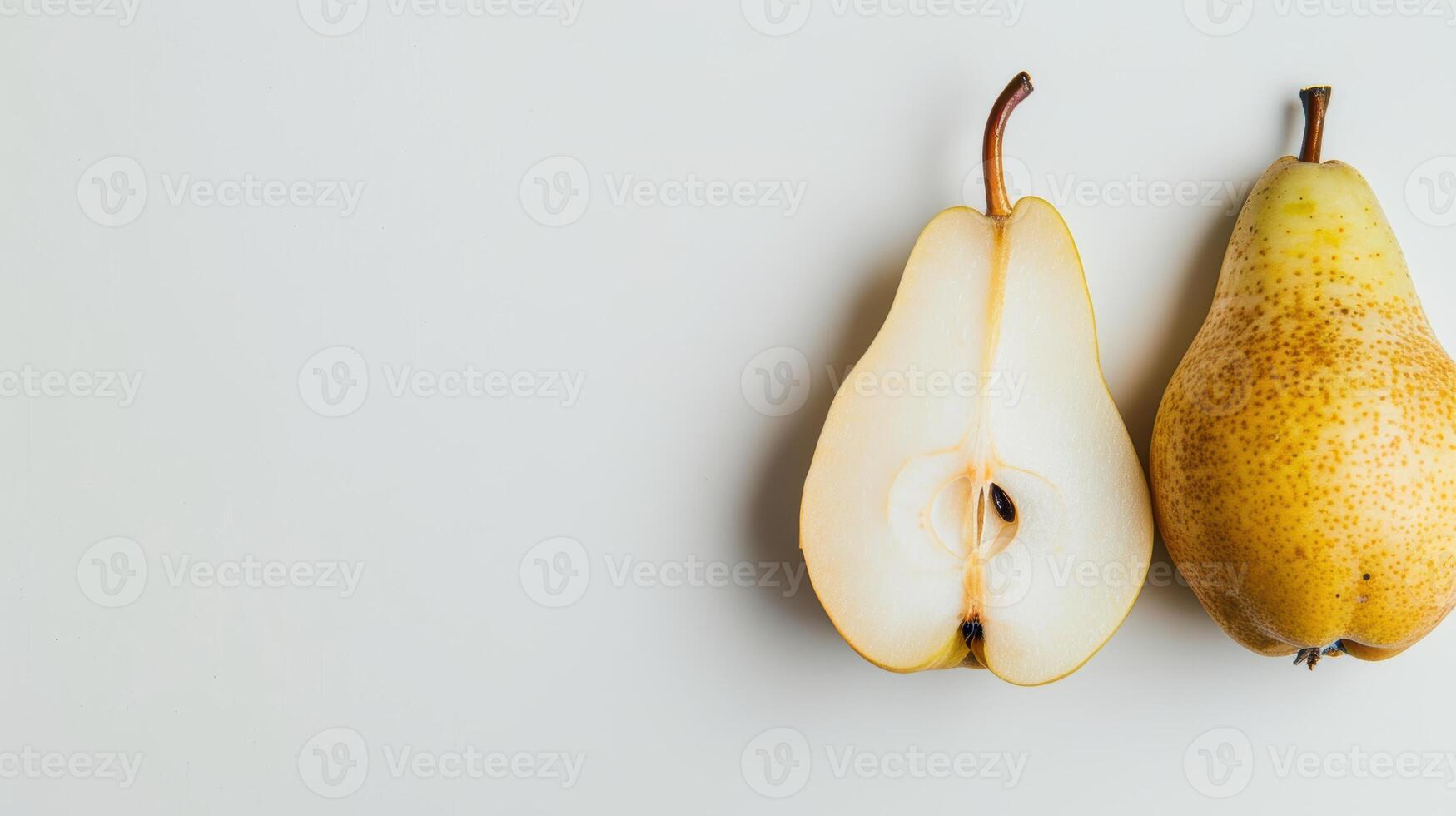 One and a half pears are lying on a white background, showing the inside of the fruit photo