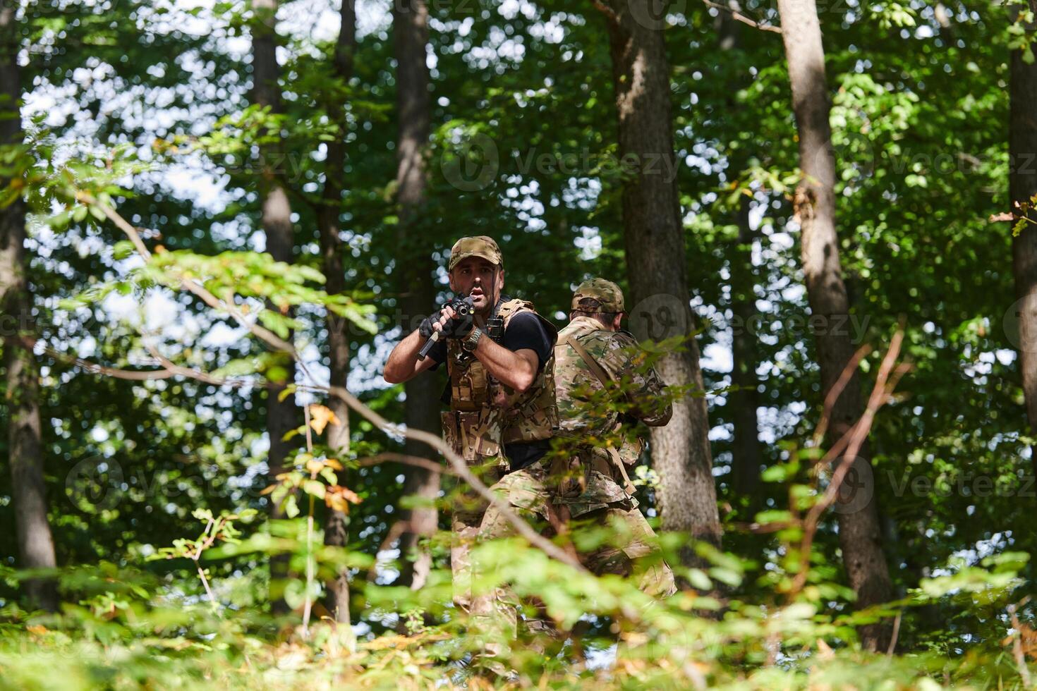 A specialized military antiterrorist unit conducts a covert operation in dense, hazardous woodland, demonstrating precision, discipline, and strategic readiness photo