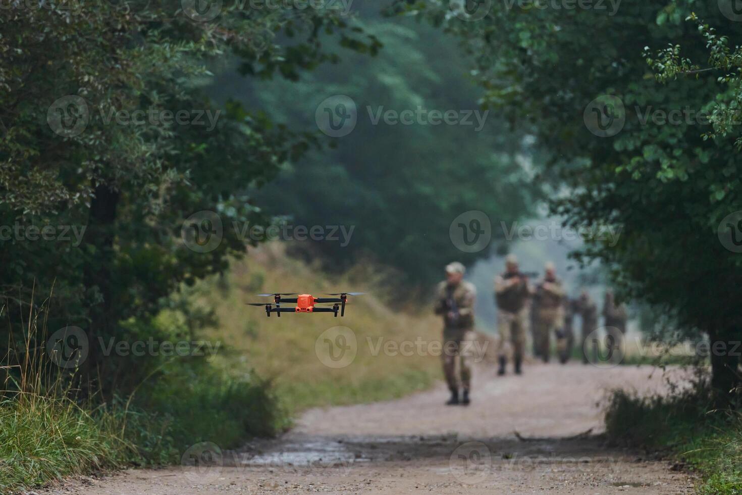 Elite military unit parading and securing the forest, utilizing drones for terrain scanning and reconnaissance, showcasing their advanced skills and specialized training in high risk operations photo