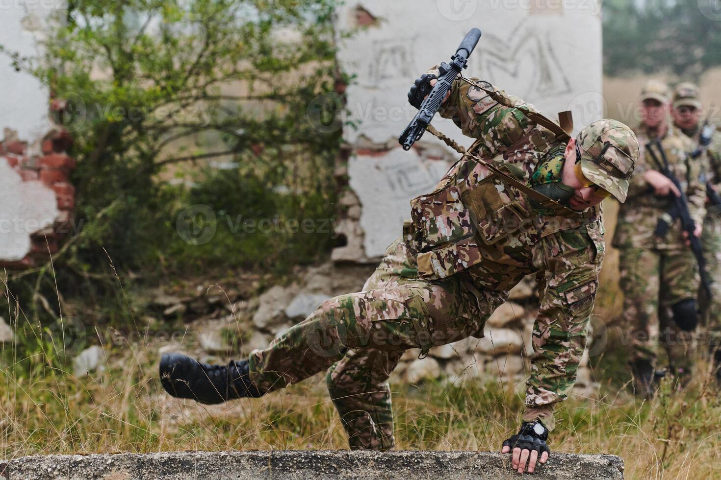 A highly trained elite military unit, clad in camouflage, skillfully navigates through perilous forest terrain, overcoming obstacles and executing a precise and covert mission photo