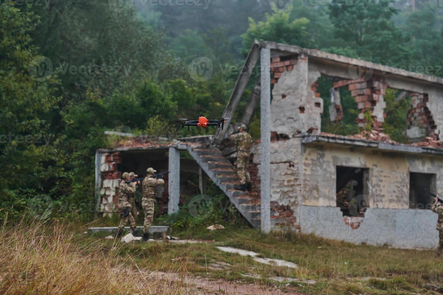 Elite military unit, equipped with state-of-the-art technology including a drone, strategically navigates and surveys dangerous wooded terrain, showcasing their precision, cooperation, and specialized photo