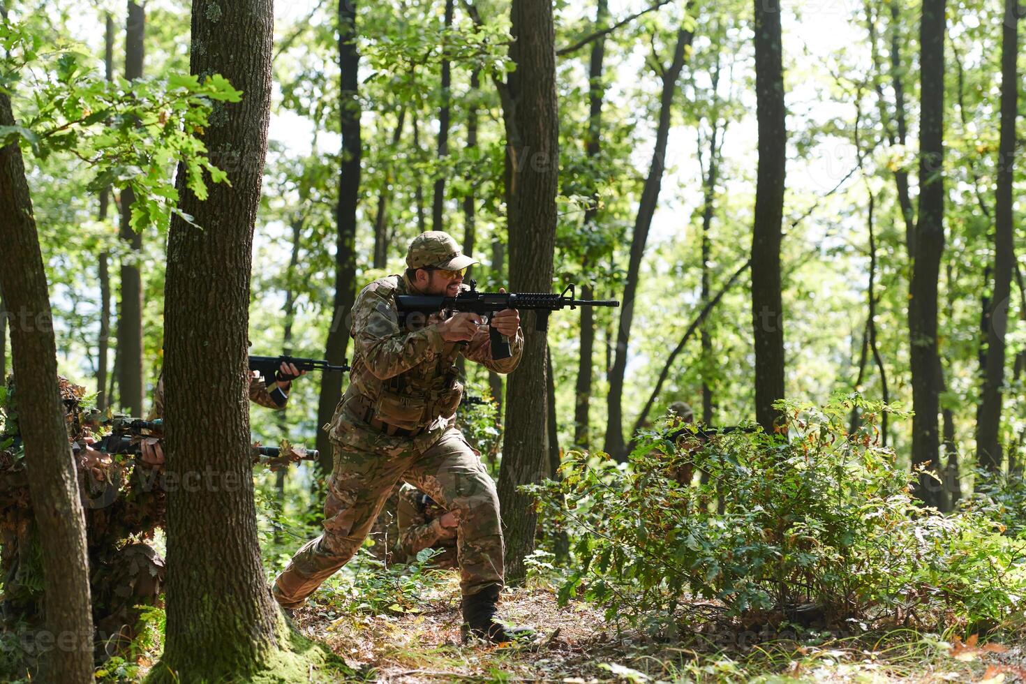 A specialized military antiterrorist unit conducts a covert operation in dense, hazardous woodland, demonstrating precision, discipline, and strategic readiness photo