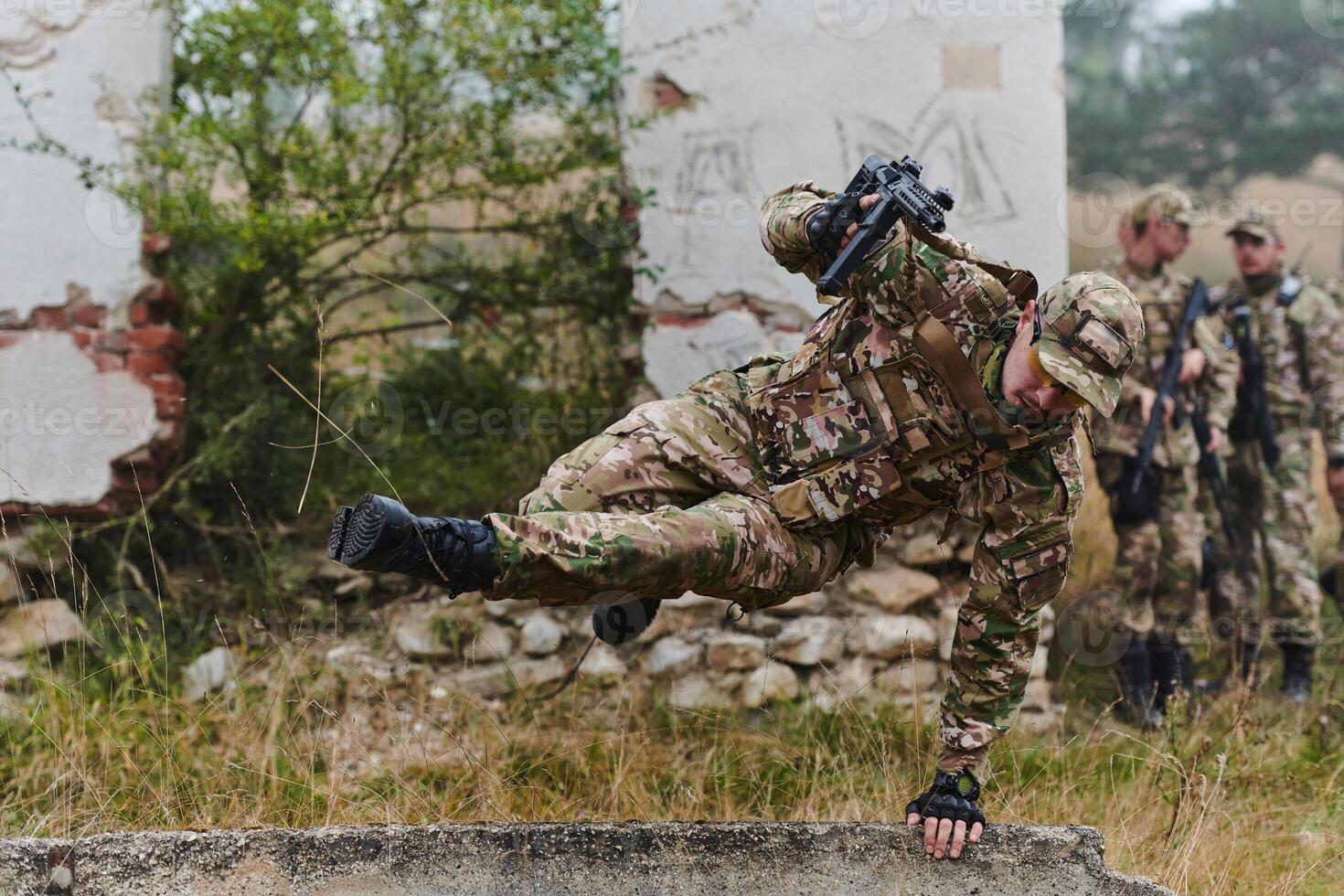 A highly trained elite military unit, clad in camouflage, skillfully navigates through perilous forest terrain, overcoming obstacles and executing a precise and covert mission photo