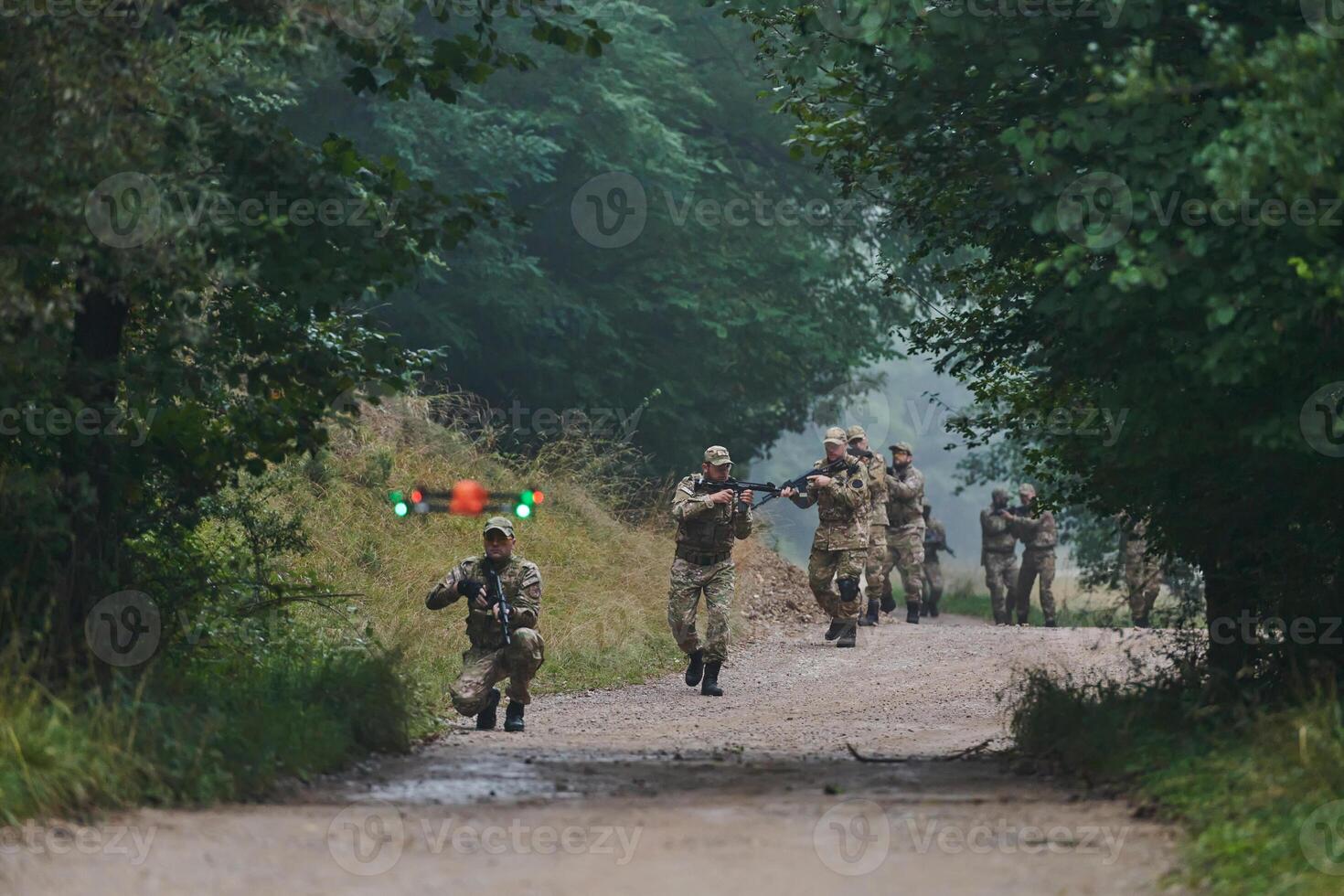 Elite military unit parading and securing the forest, utilizing drones for terrain scanning and reconnaissance, showcasing their advanced skills and specialized training in high risk operations photo