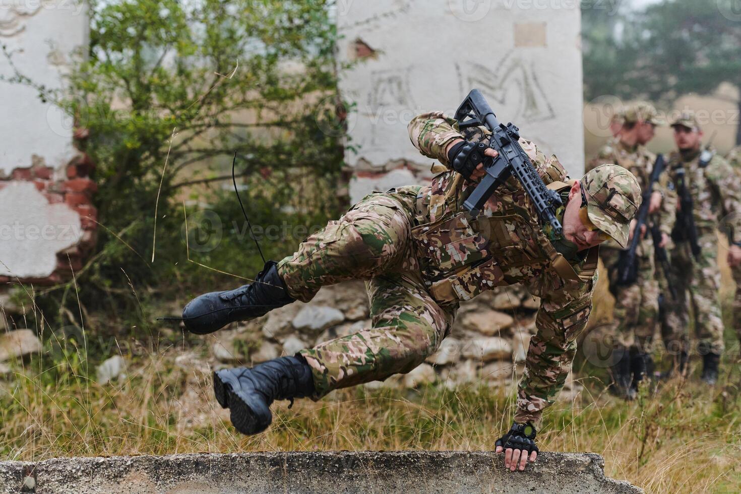 A highly trained elite military unit, clad in camouflage, skillfully navigates through perilous forest terrain, overcoming obstacles and executing a precise and covert mission photo