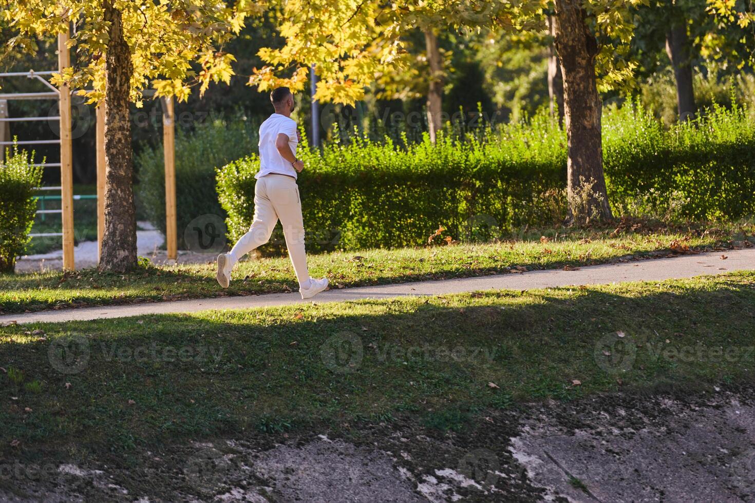 A handsome man maintains his healthy lifestyle as he runs along beautiful natural trails, embodying the essence of fitness, wellness, and vitality in the midst of scenic outdoor surroundings. photo