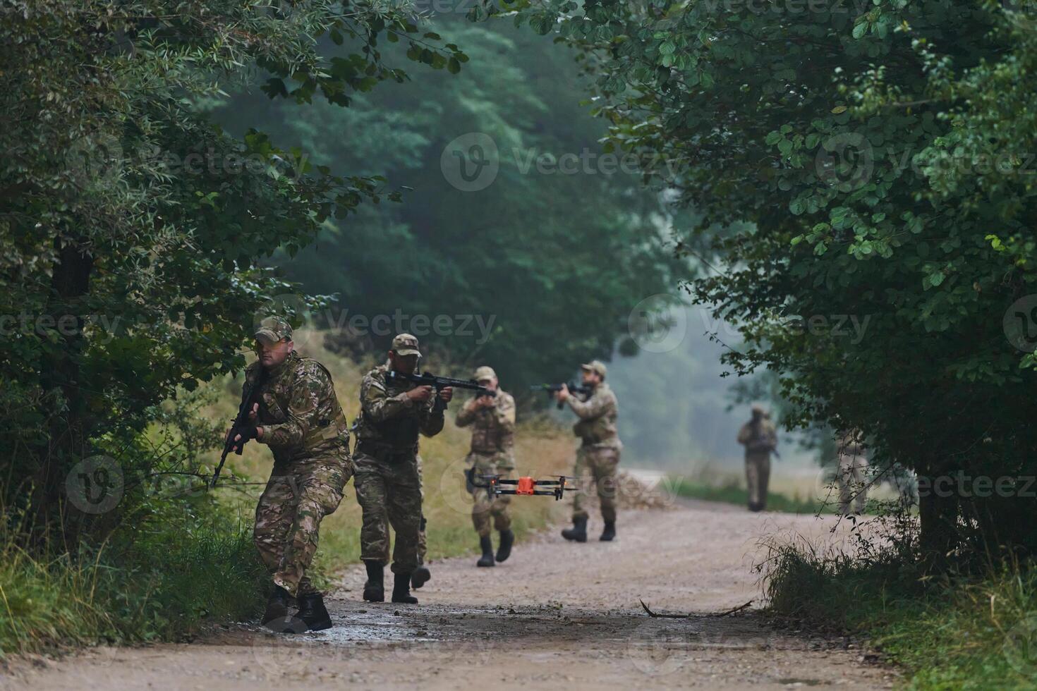 Elite military unit parading and securing the forest, utilizing drones for terrain scanning and reconnaissance, showcasing their advanced skills and specialized training in high risk operations photo