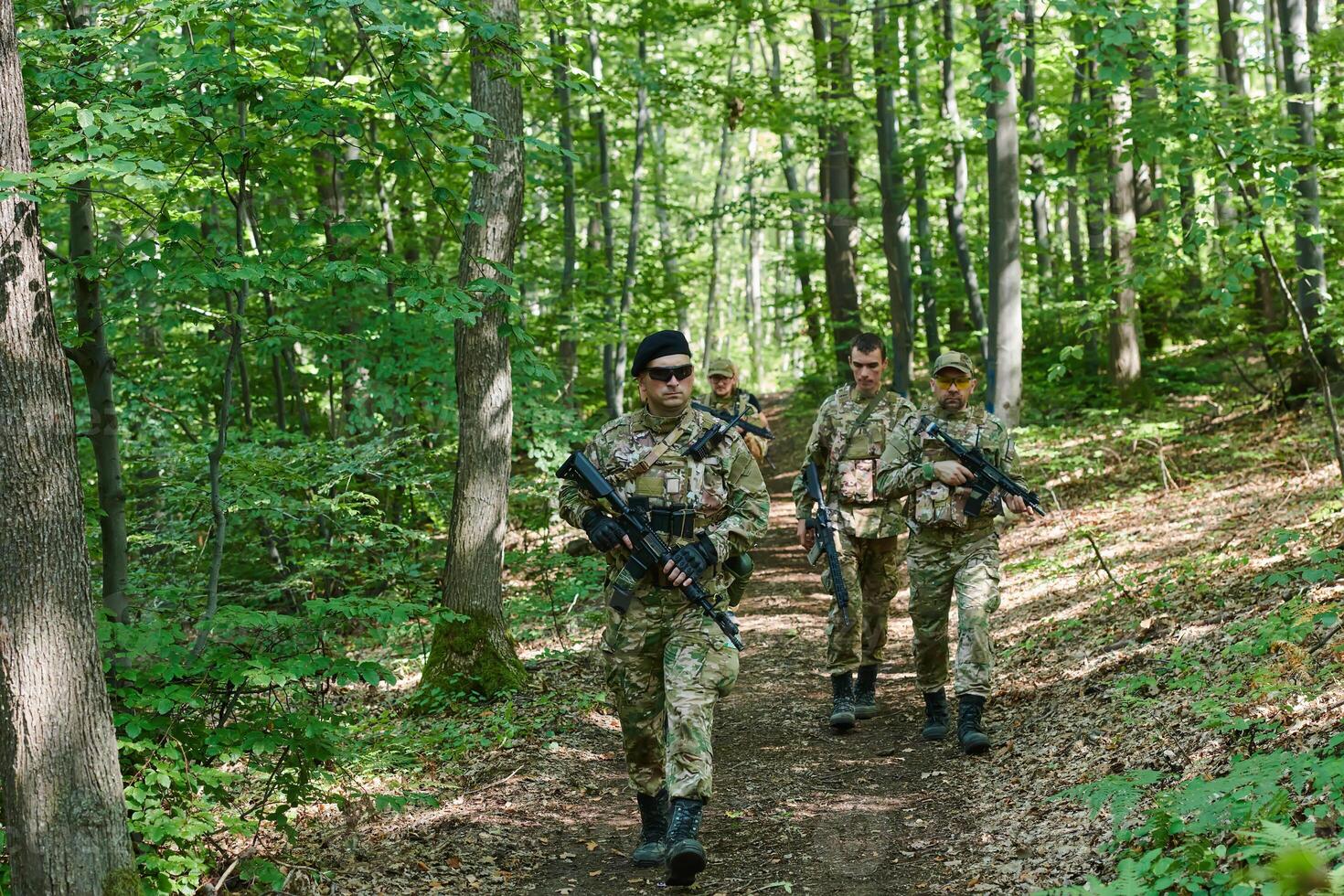 A specialized military antiterrorist unit conducts a covert operation in dense, hazardous woodland, demonstrating precision, discipline, and strategic readiness photo