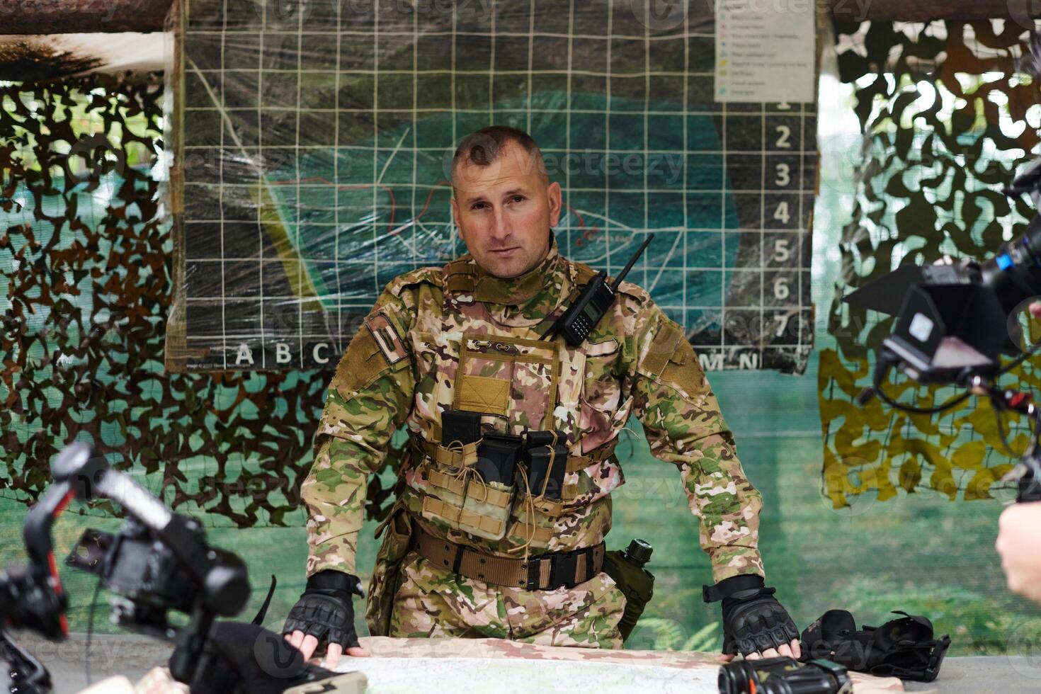 The esteemed leader of an elite military unit, strategic brilliance unfolds as he meticulously devises tactical plans for the upcoming military operation, surrounded by cutting-edge technology and a photo