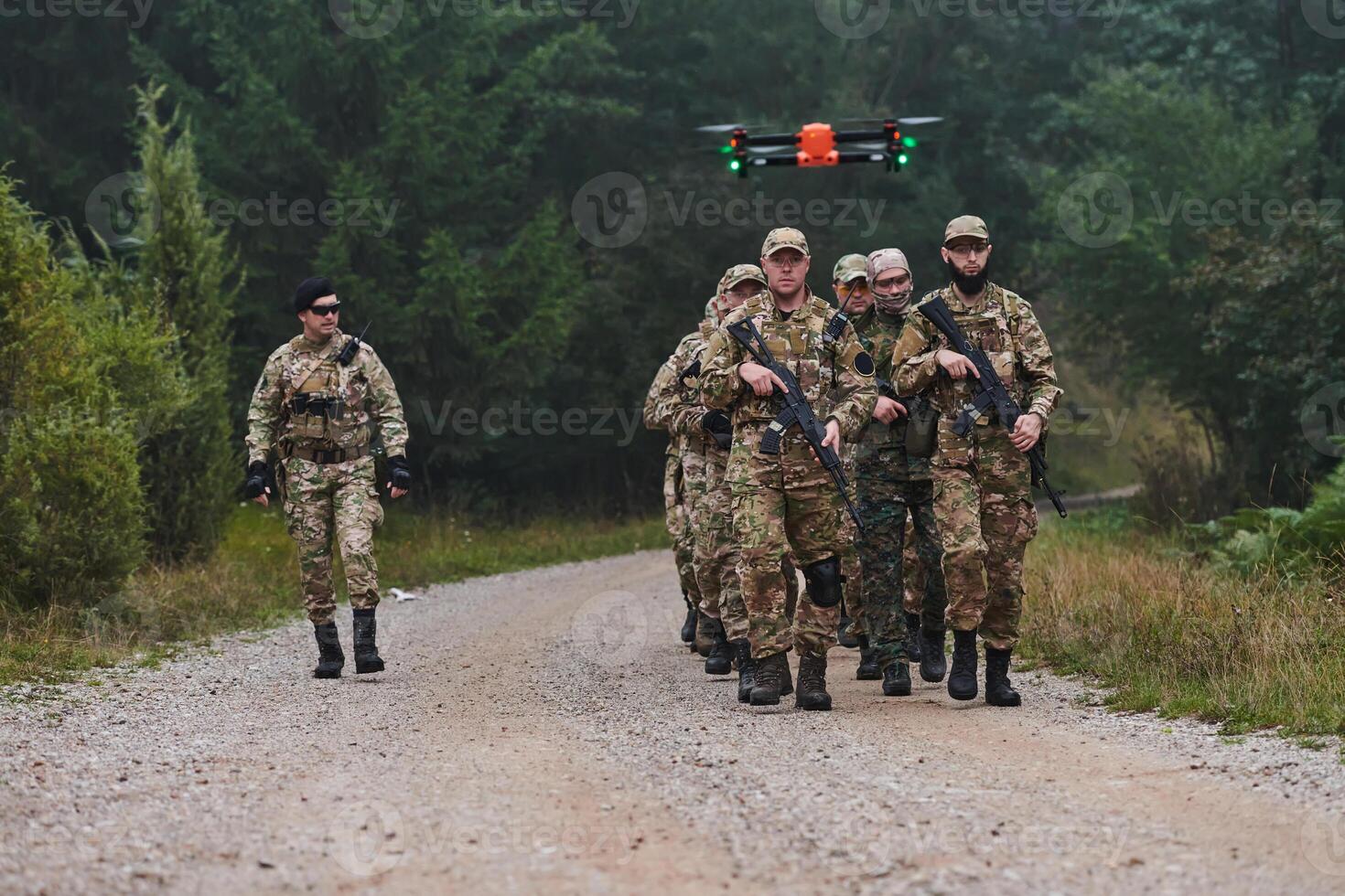 An elite military unit, led by a major, confidently parades through dense forest, showcasing precision, discipline, and readiness for high-risk operations photo