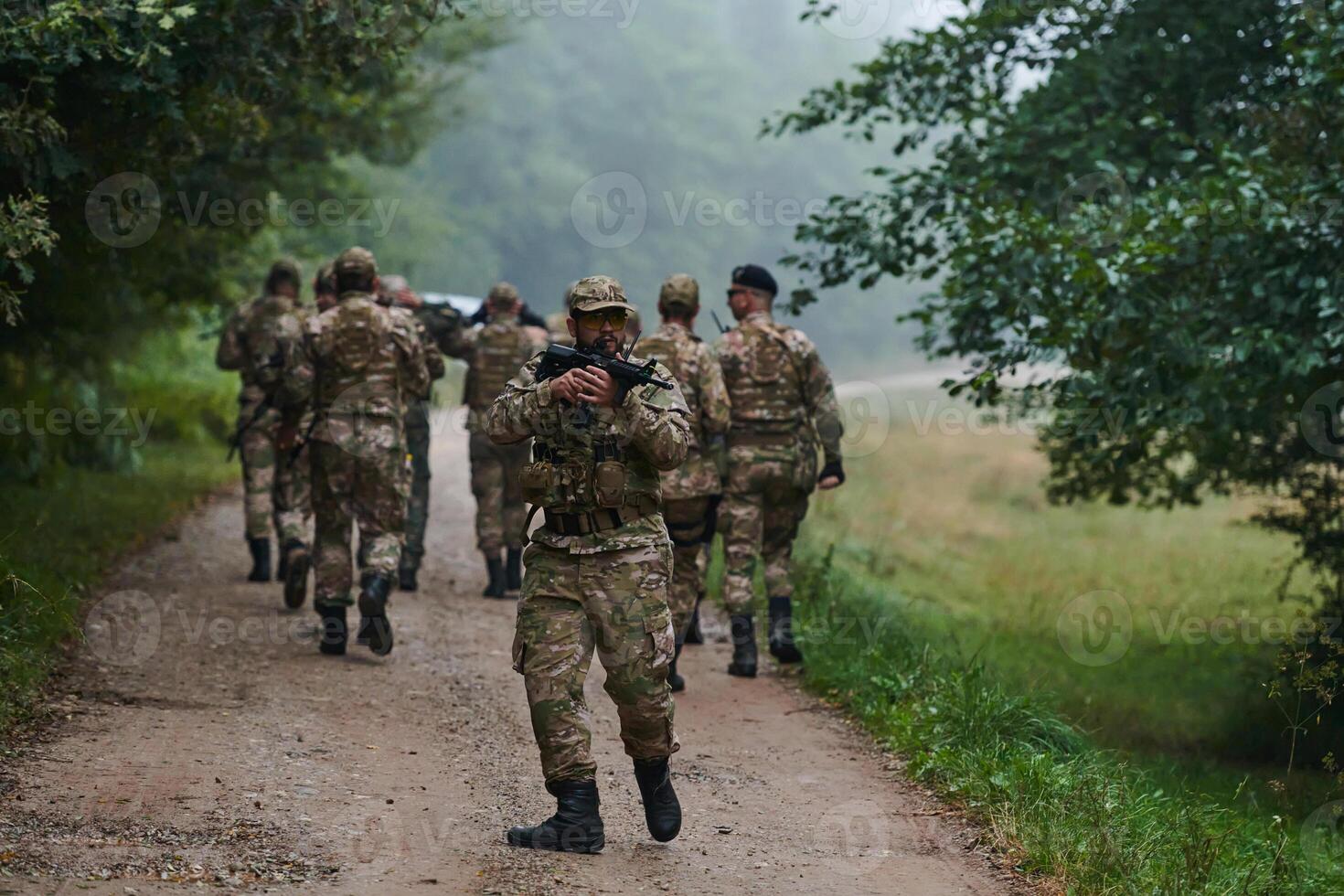 A group of elite soldiers leads captives through a military camp, showcasing a tense atmosphere of detention and security operations photo