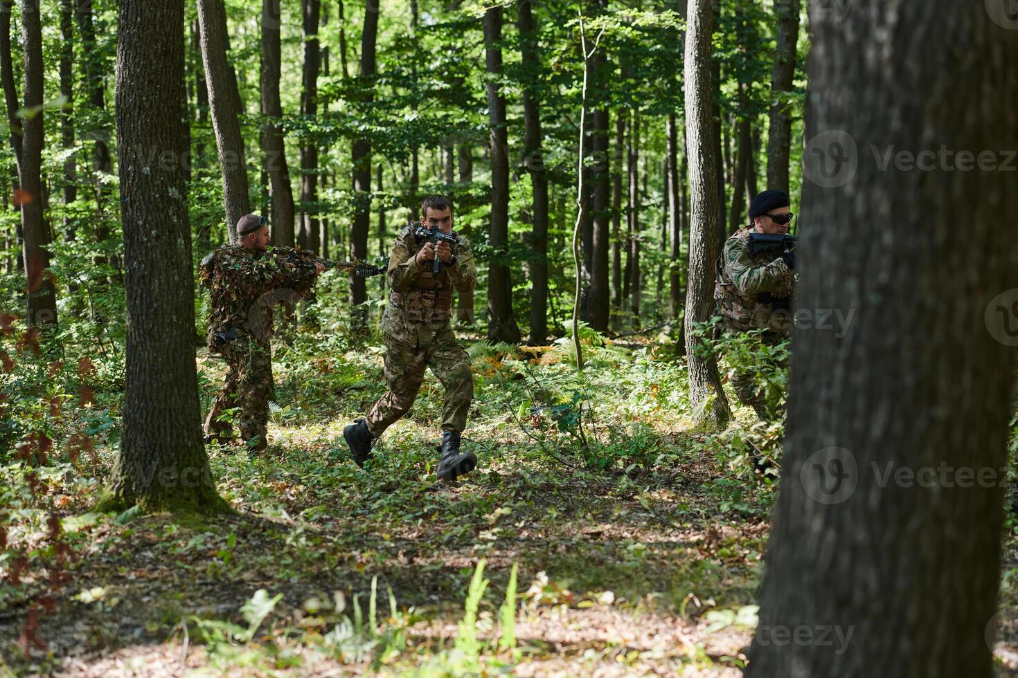 A specialized military antiterrorist unit conducts a covert operation in dense, hazardous woodland, demonstrating precision, discipline, and strategic readiness photo