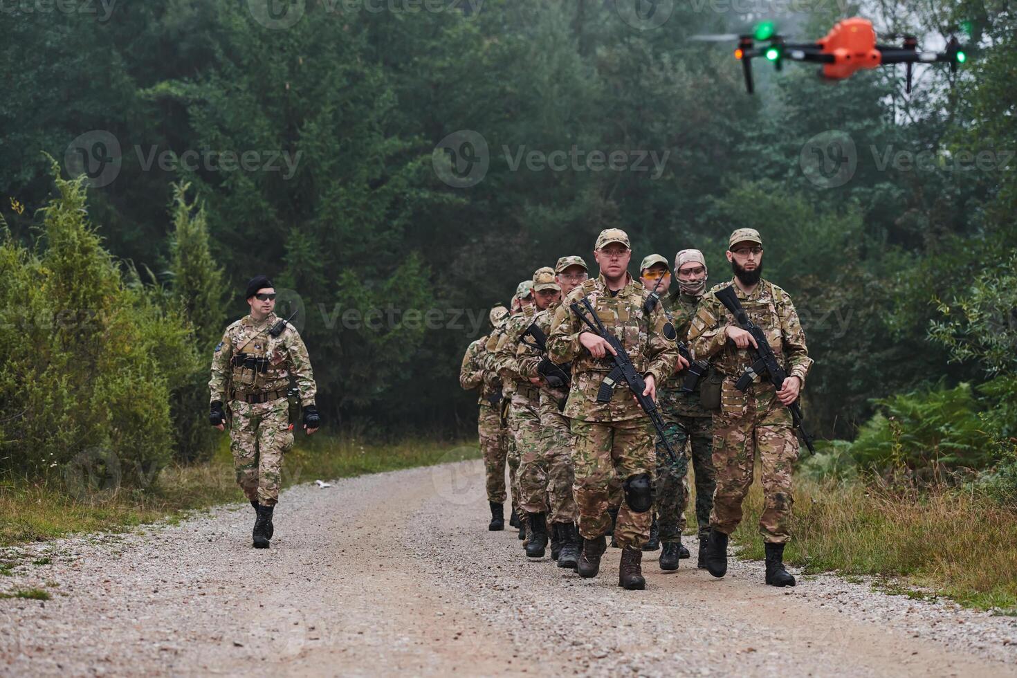 An elite military unit, led by a major, confidently parades through dense forest, showcasing precision, discipline, and readiness for high-risk operations photo