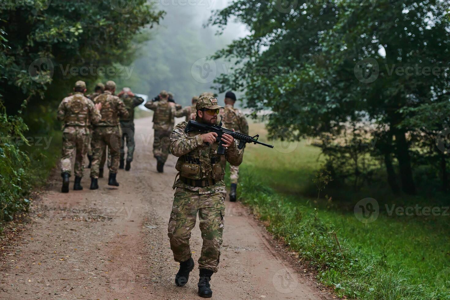 A group of elite soldiers leads captives through a military camp, showcasing a tense atmosphere of detention and security operations photo
