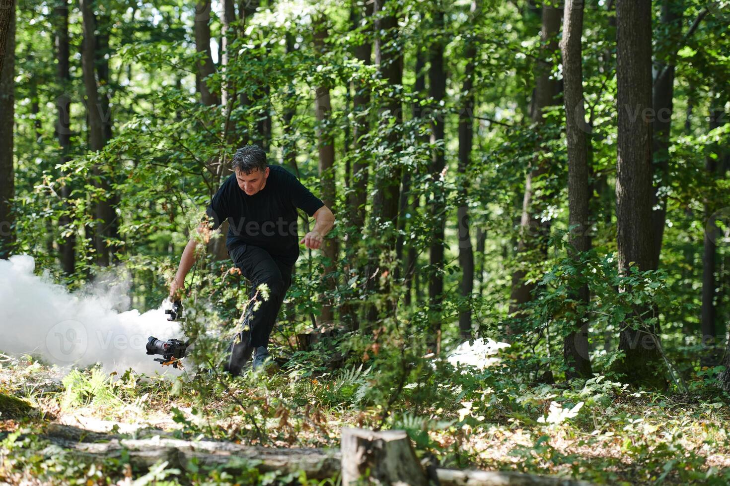 A videographer captures the intensity of a perilous military operation, documenting soldiers in action amidst the dense forest, showcasing the hazardous conditions and tactical maneuvers undertaken by photo