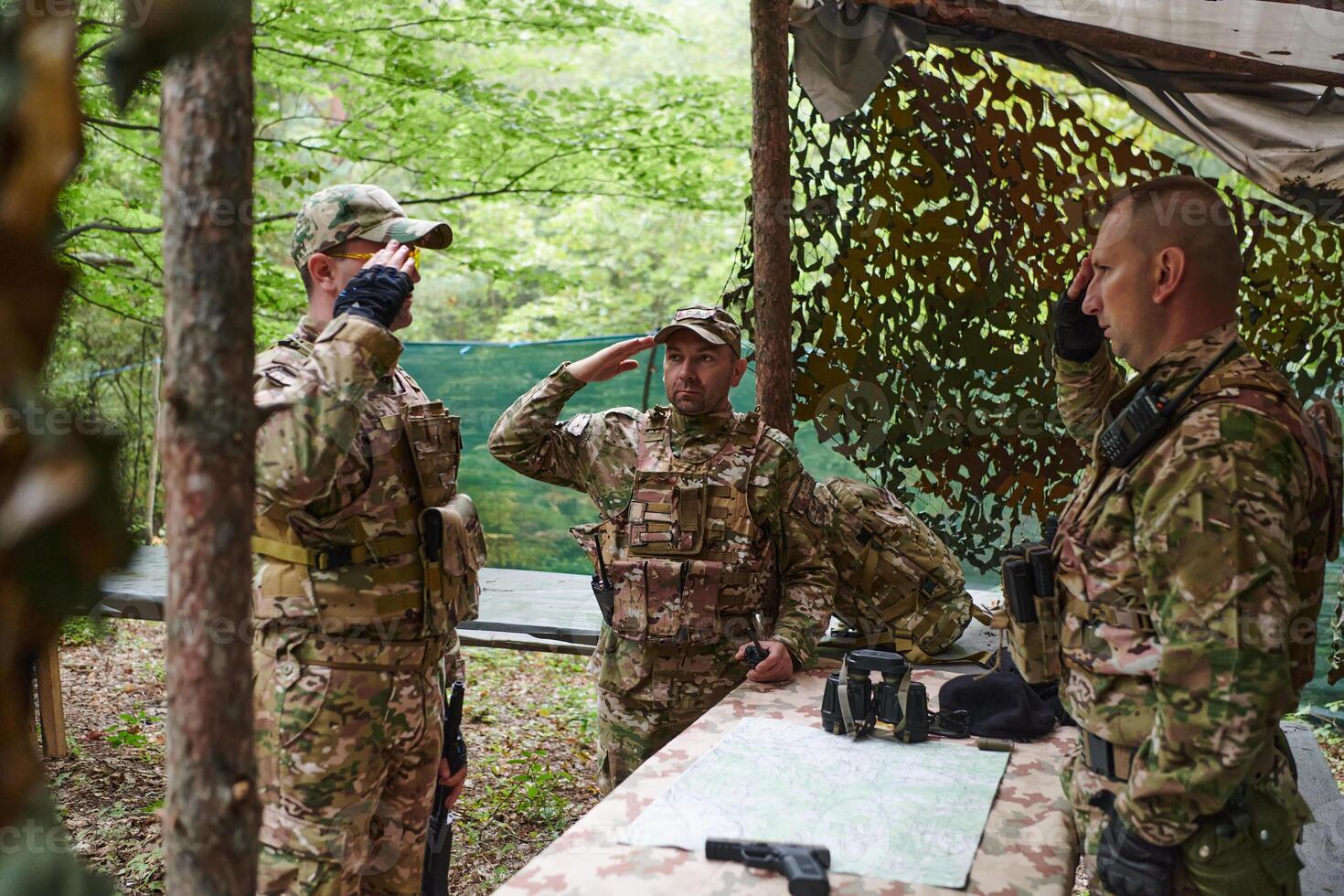 A highly trained military unit strategizes and organizes a tactical mission while studying a military map during a briefing session photo