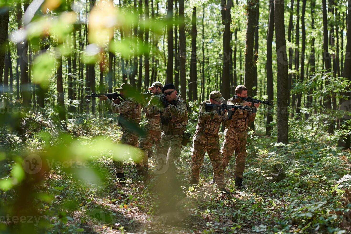 A specialized military antiterrorist unit conducts a covert operation in dense, hazardous woodland, demonstrating precision, discipline, and strategic readiness photo
