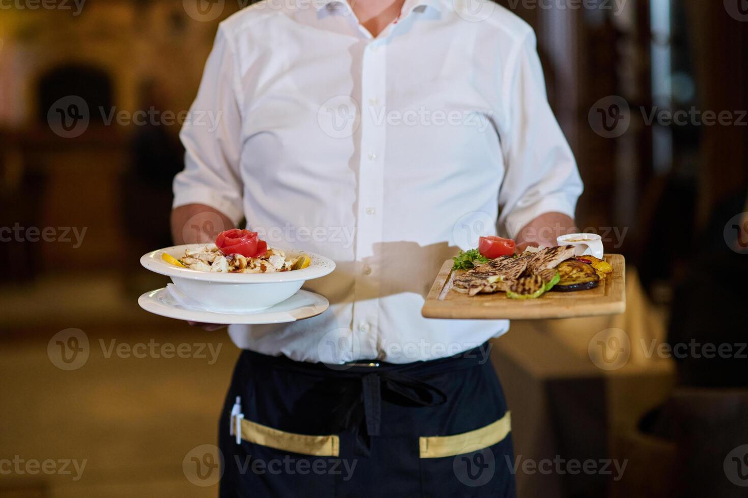 A courteous waiter provides impeccable service to an elderly family and their friends, creating a convivial atmosphere as they gather for a shared lunch, indulging in the diverse and delectable photo