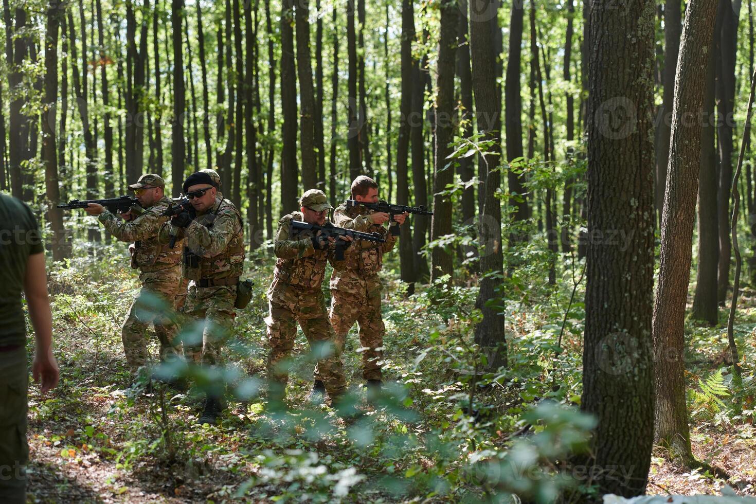 A specialized military antiterrorist unit conducts a covert operation in dense, hazardous woodland, demonstrating precision, discipline, and strategic readiness photo