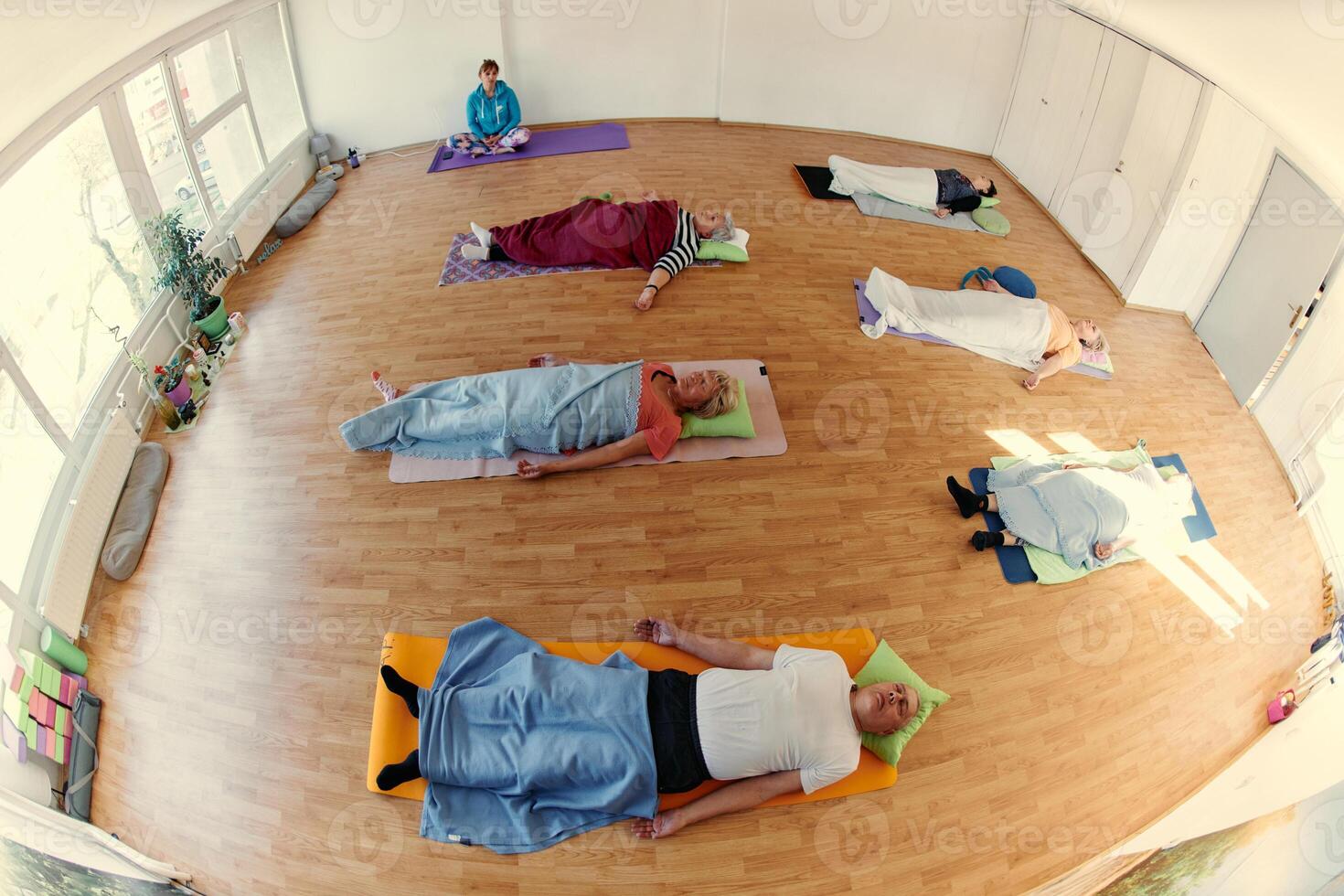 Senior Women Embrace Wellness. Yoga and Stretching in a Sunlit Space photo