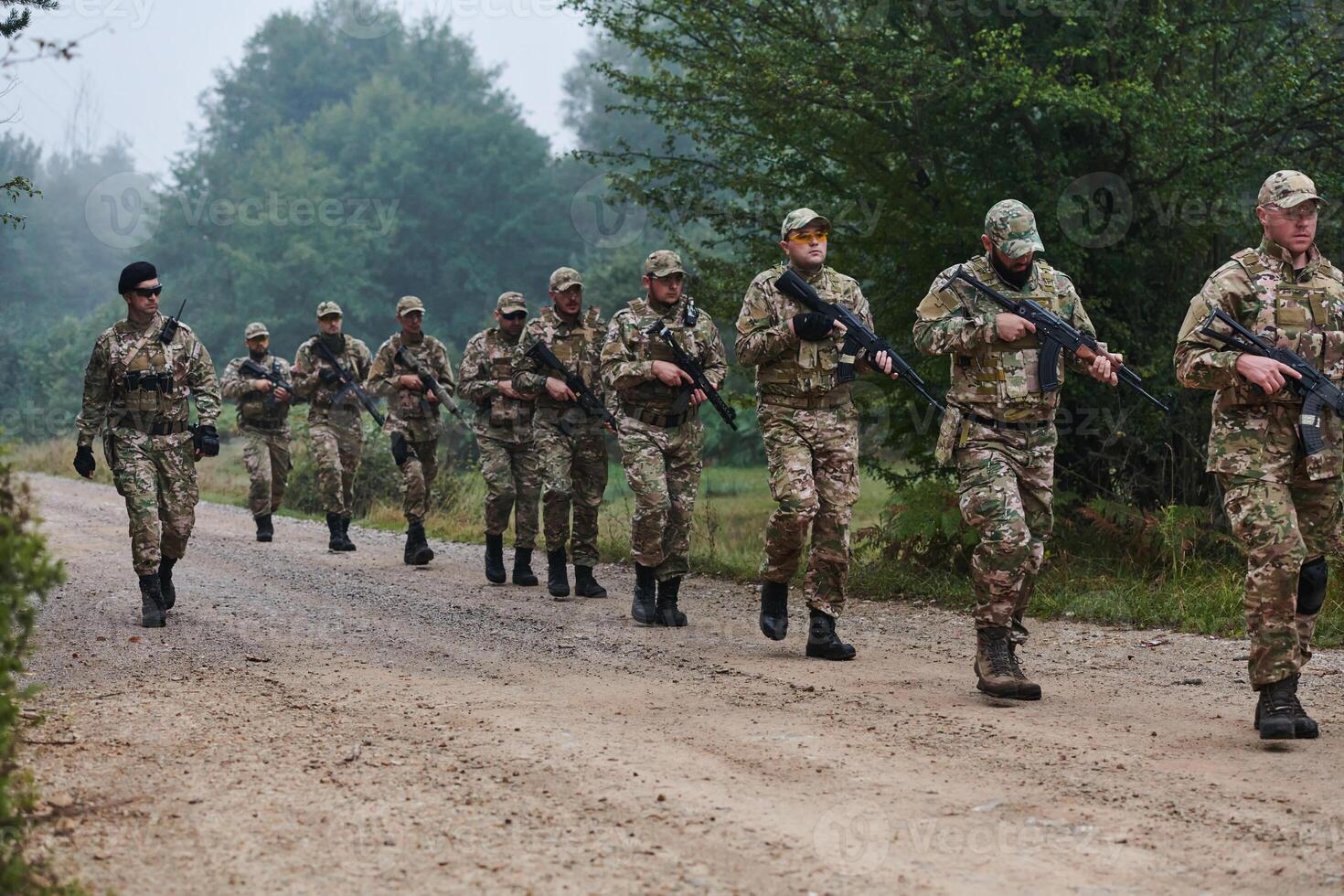 An elite military unit, led by a major, confidently parades through dense forest, showcasing precision, discipline, and readiness for high-risk operations photo