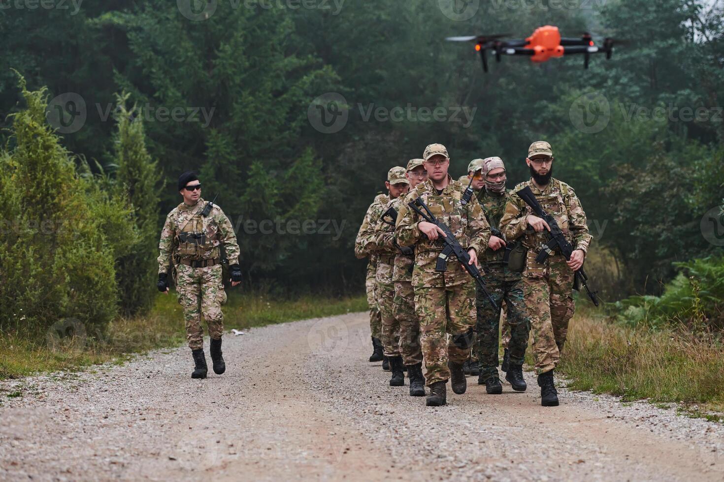 An elite military unit, led by a major, confidently parades through dense forest, showcasing precision, discipline, and readiness for high-risk operations photo
