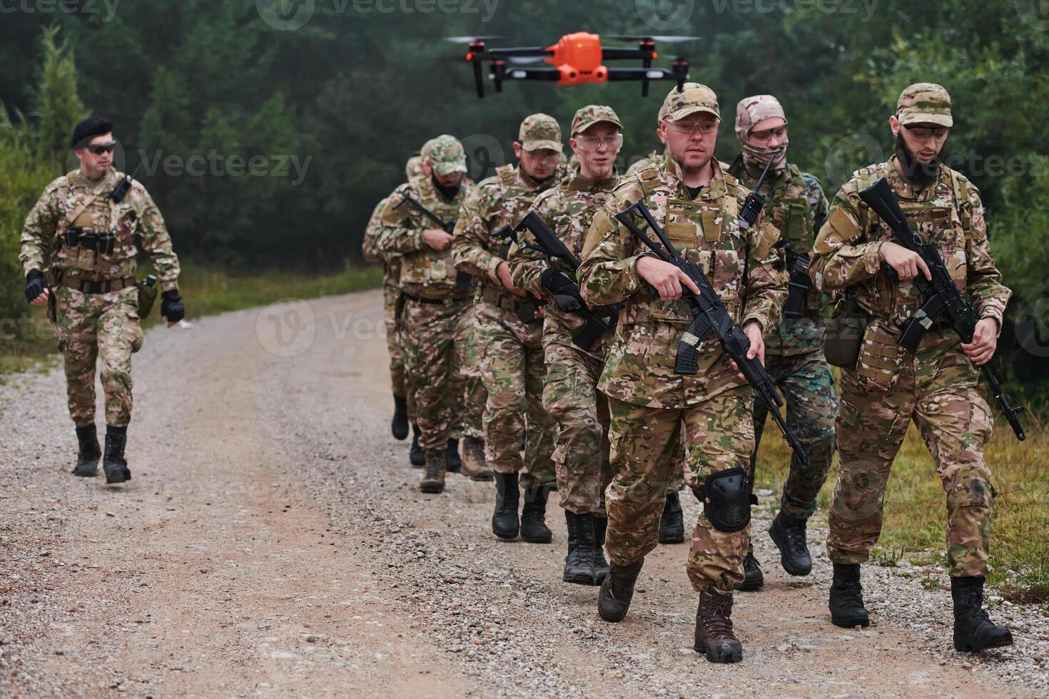 An elite military unit, led by a major, confidently parades through dense forest, showcasing precision, discipline, and readiness for high-risk operations photo